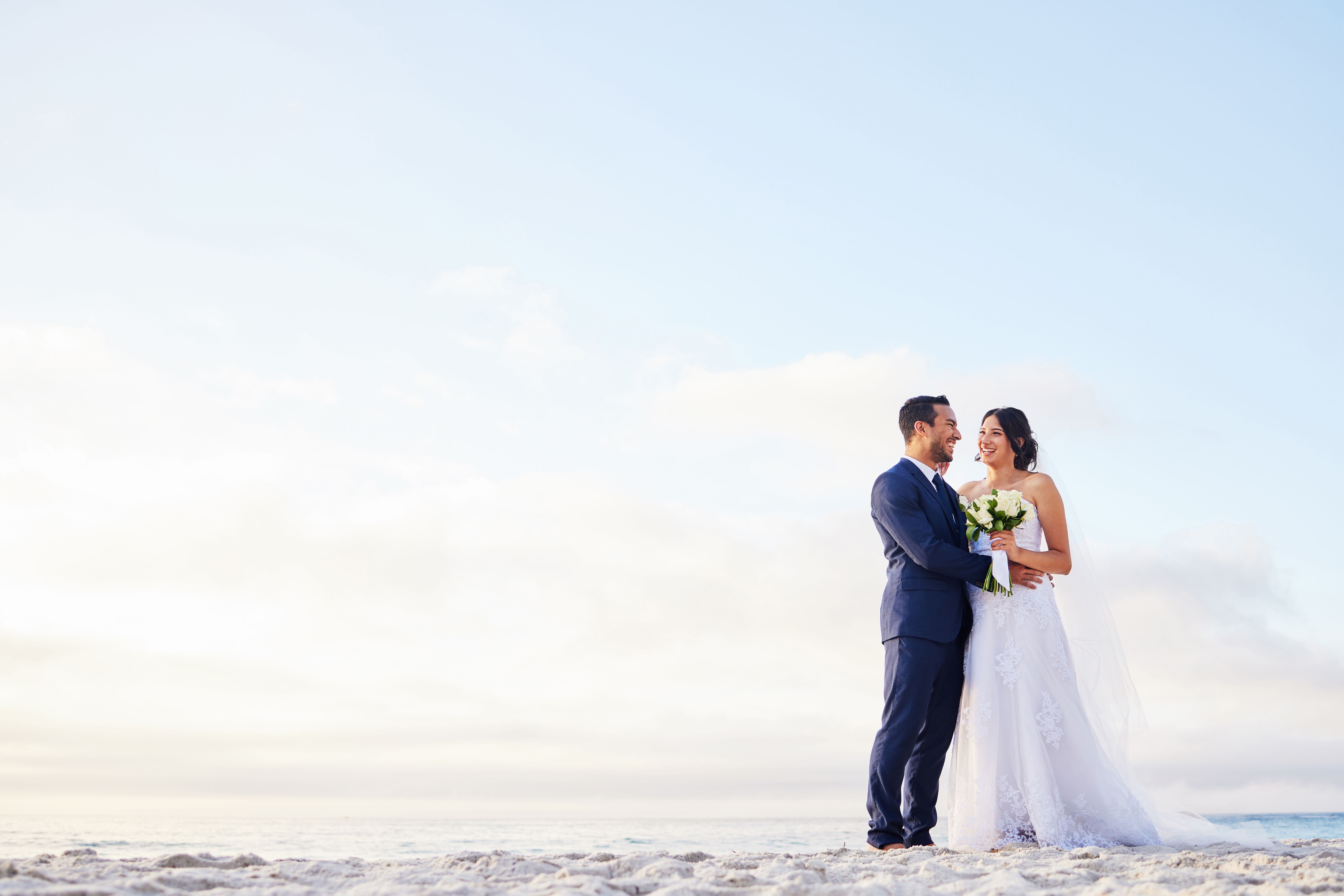 Shot of a young couple on the beach on their wedding day