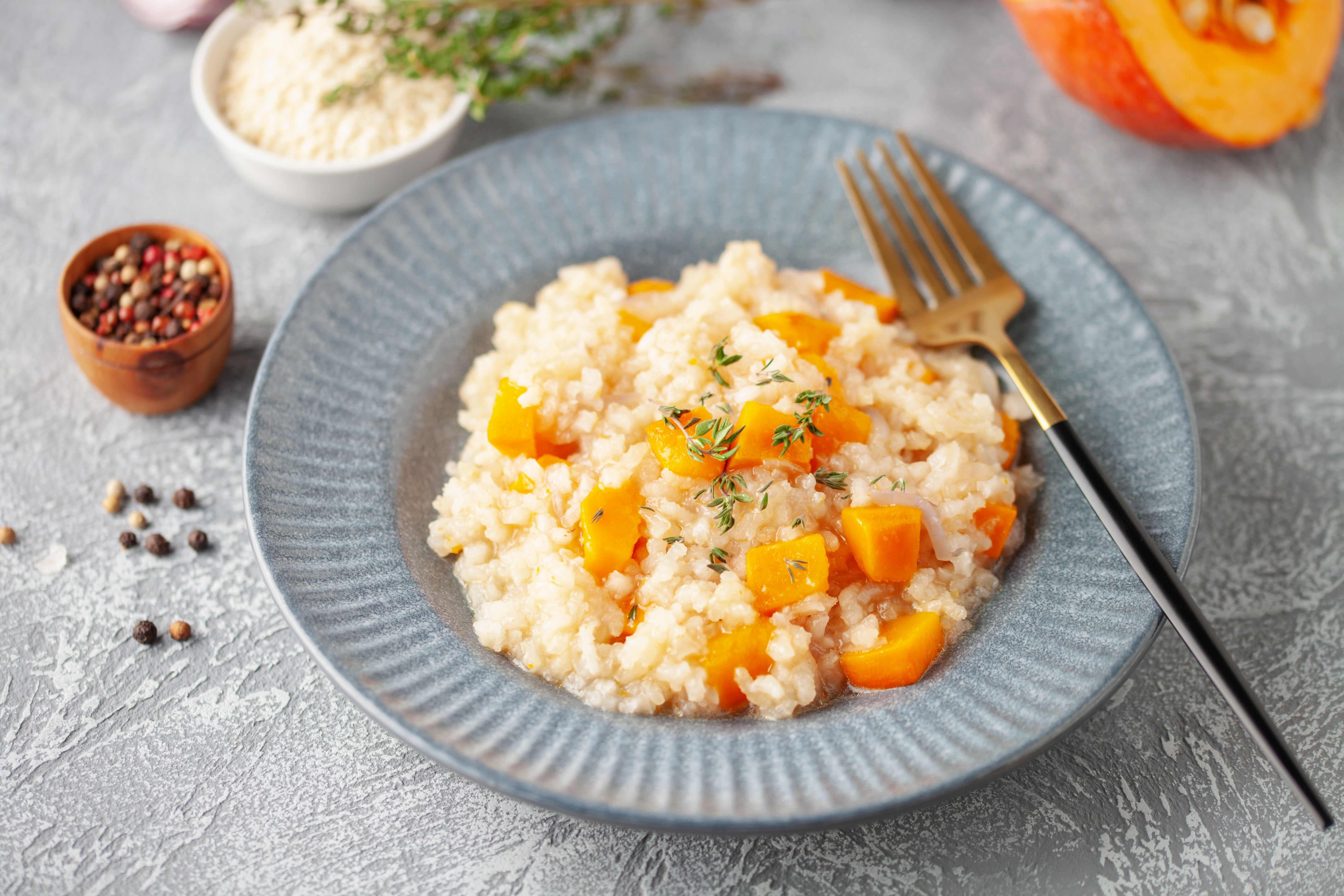 Pumpkin risotto with fresh thyme in plate. Italian Food Pumpkin risotto with fresh thyme in plate. Italian Food