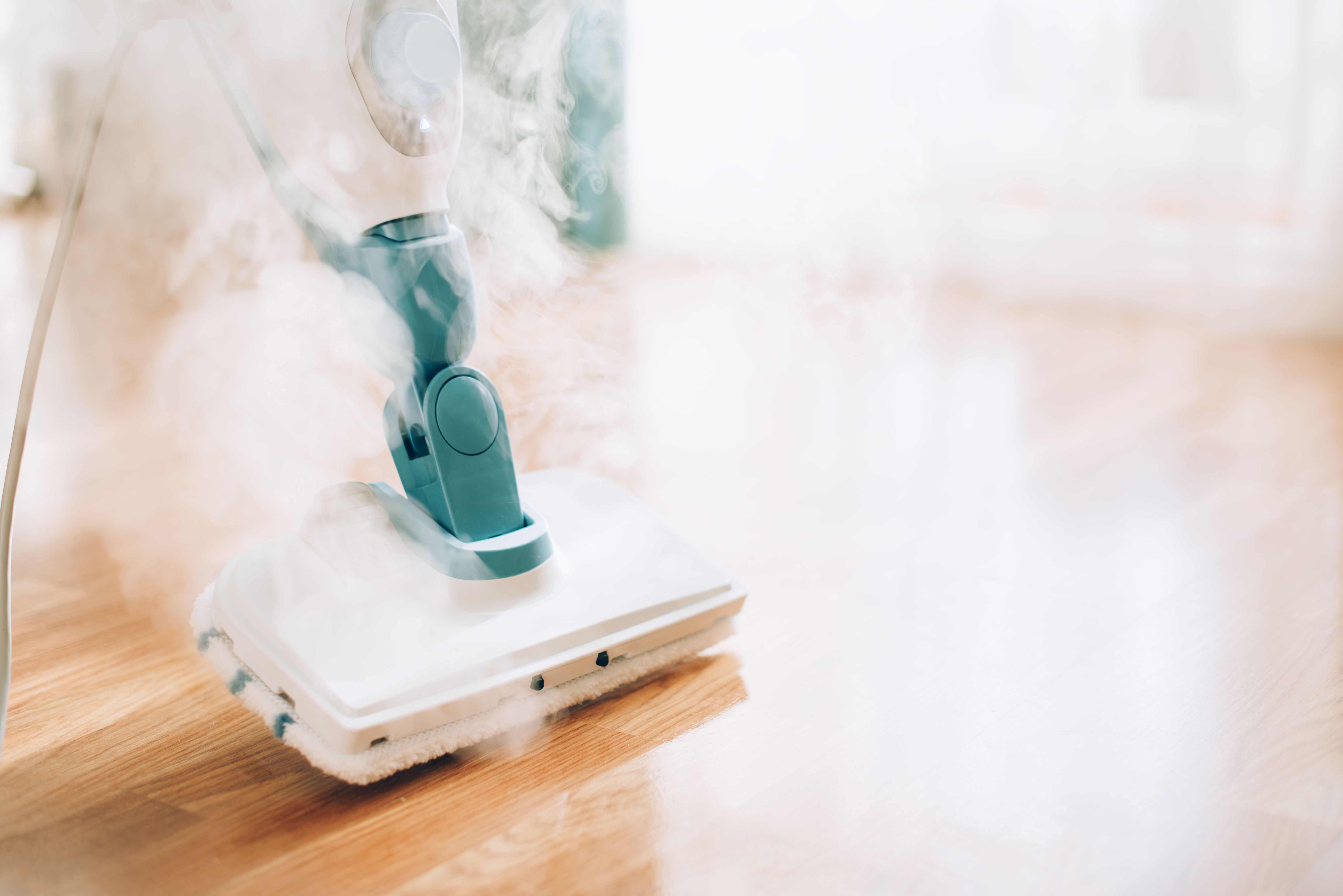 Steam cleaner mop cleaining floor. Banner with copy space. Cleaning service concept Steam cleaner mop cleaining floor. Banner with copy space. Cleaning service concept