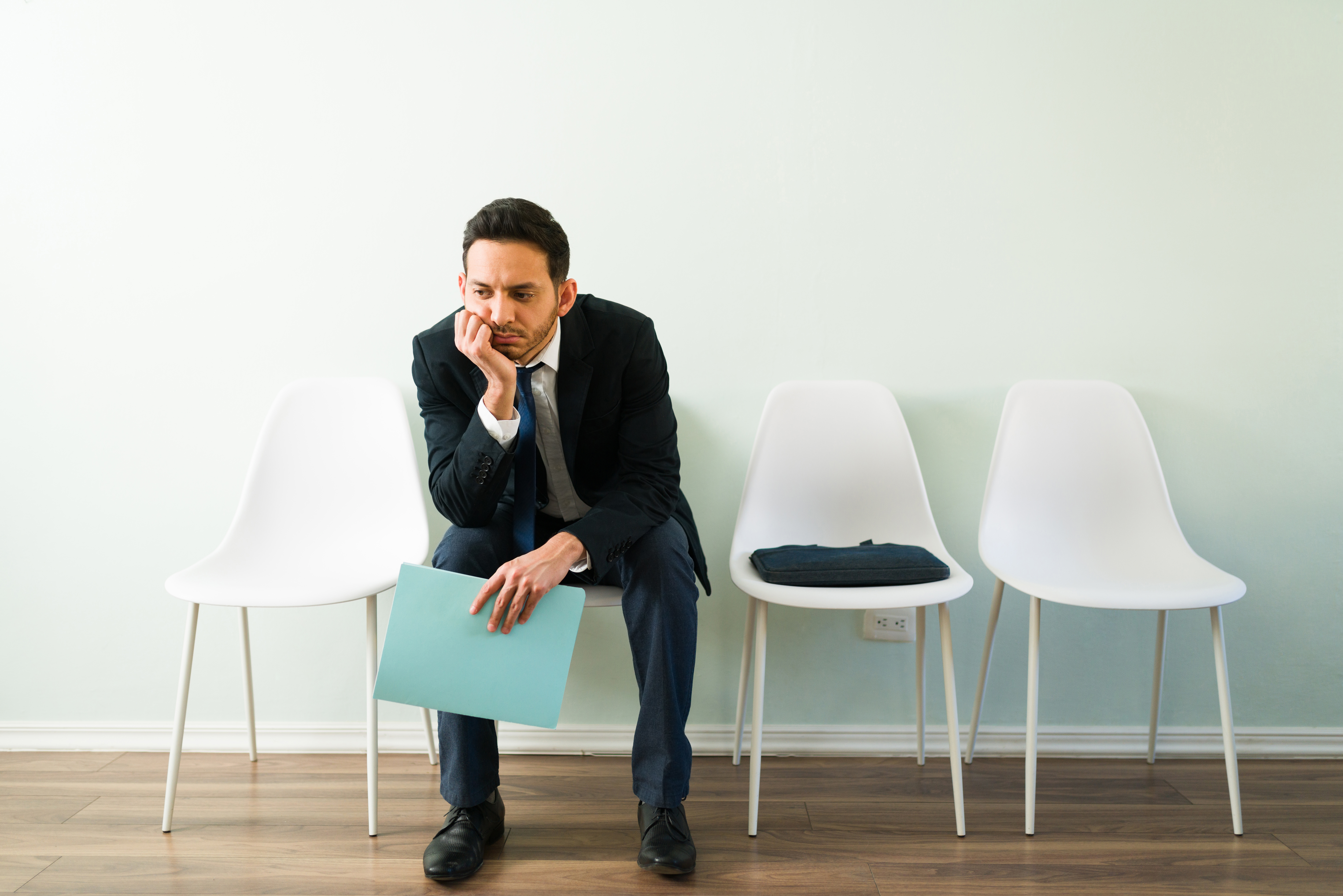 Sad businessman applying for a new job and waiting