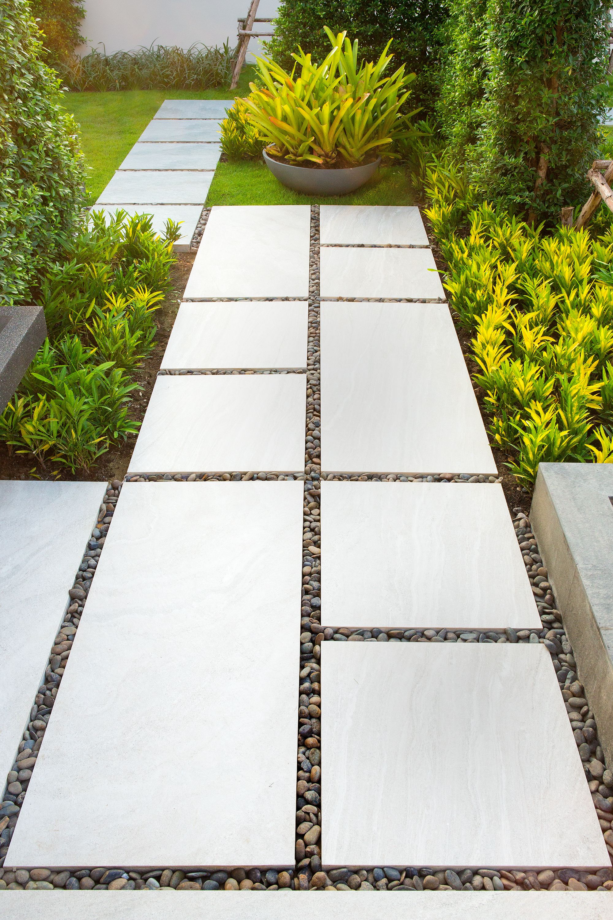 The walkway is made of stone in the garden. The walkway is made of stone in the garden.