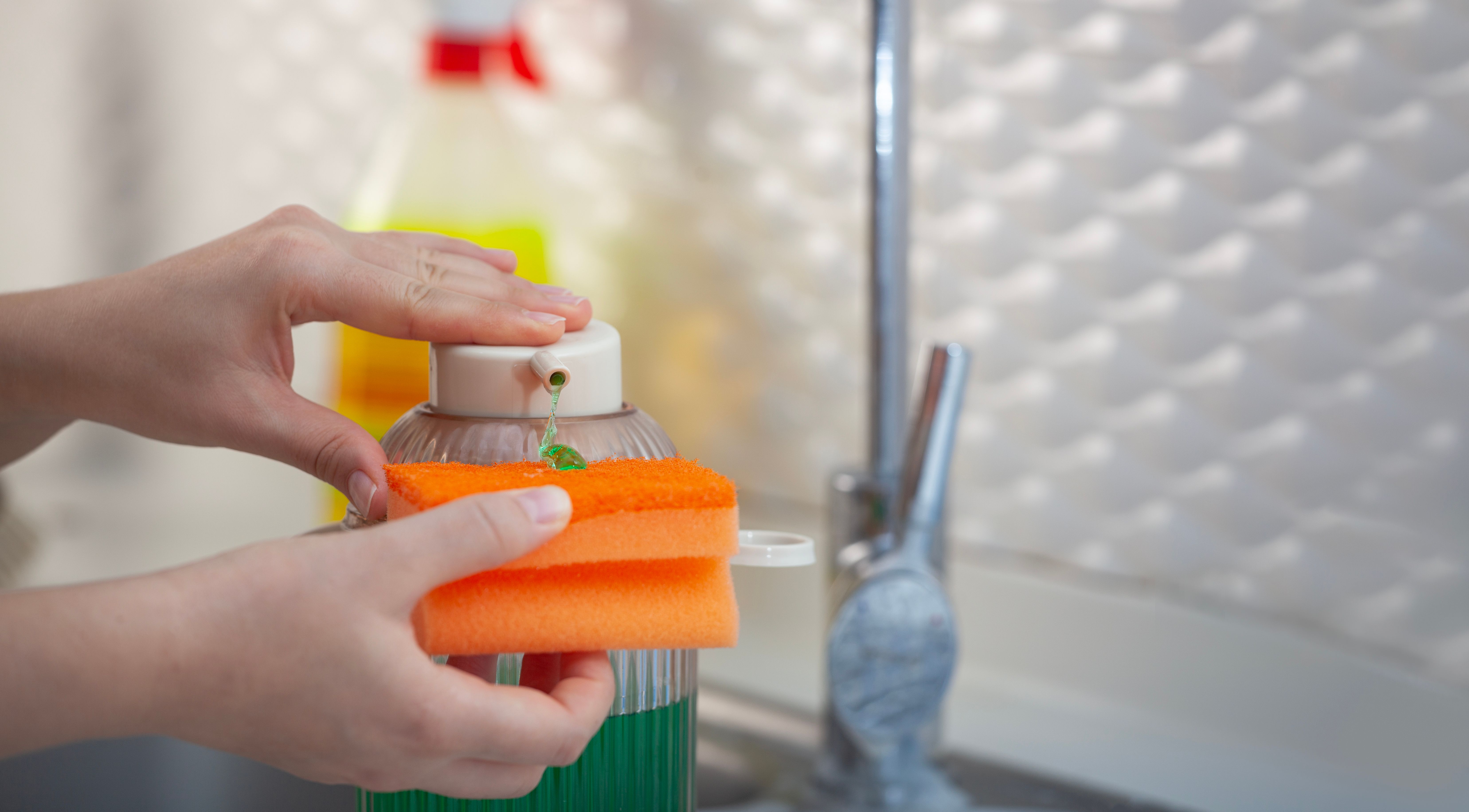 Detergent Bottle and Sponge on Kitchen Table