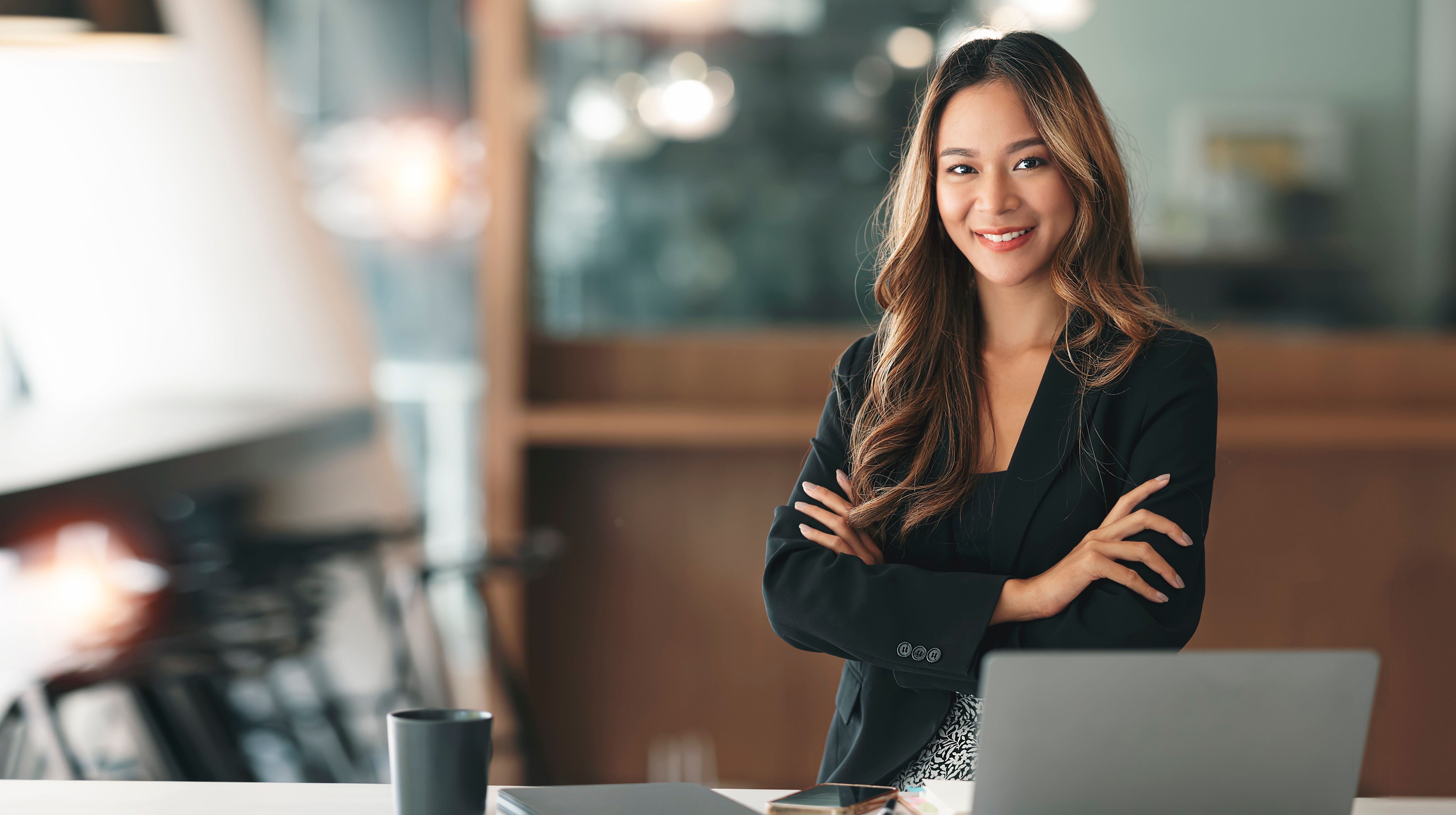Elegant businesswoman standing in office. Confident businesswoman smiling at the camera.