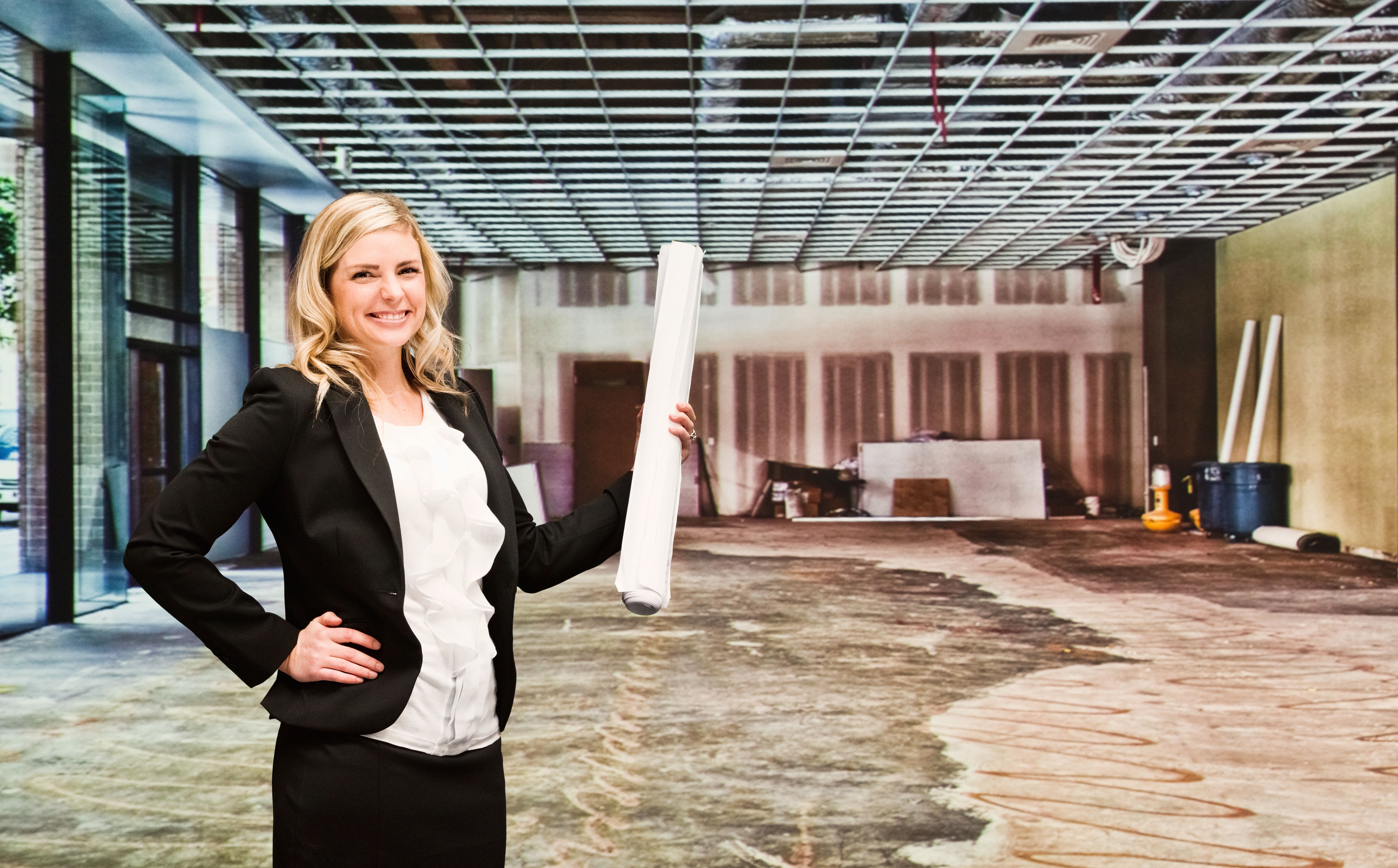 Smiling architect standing in construction site Smiling architect standing in construction site