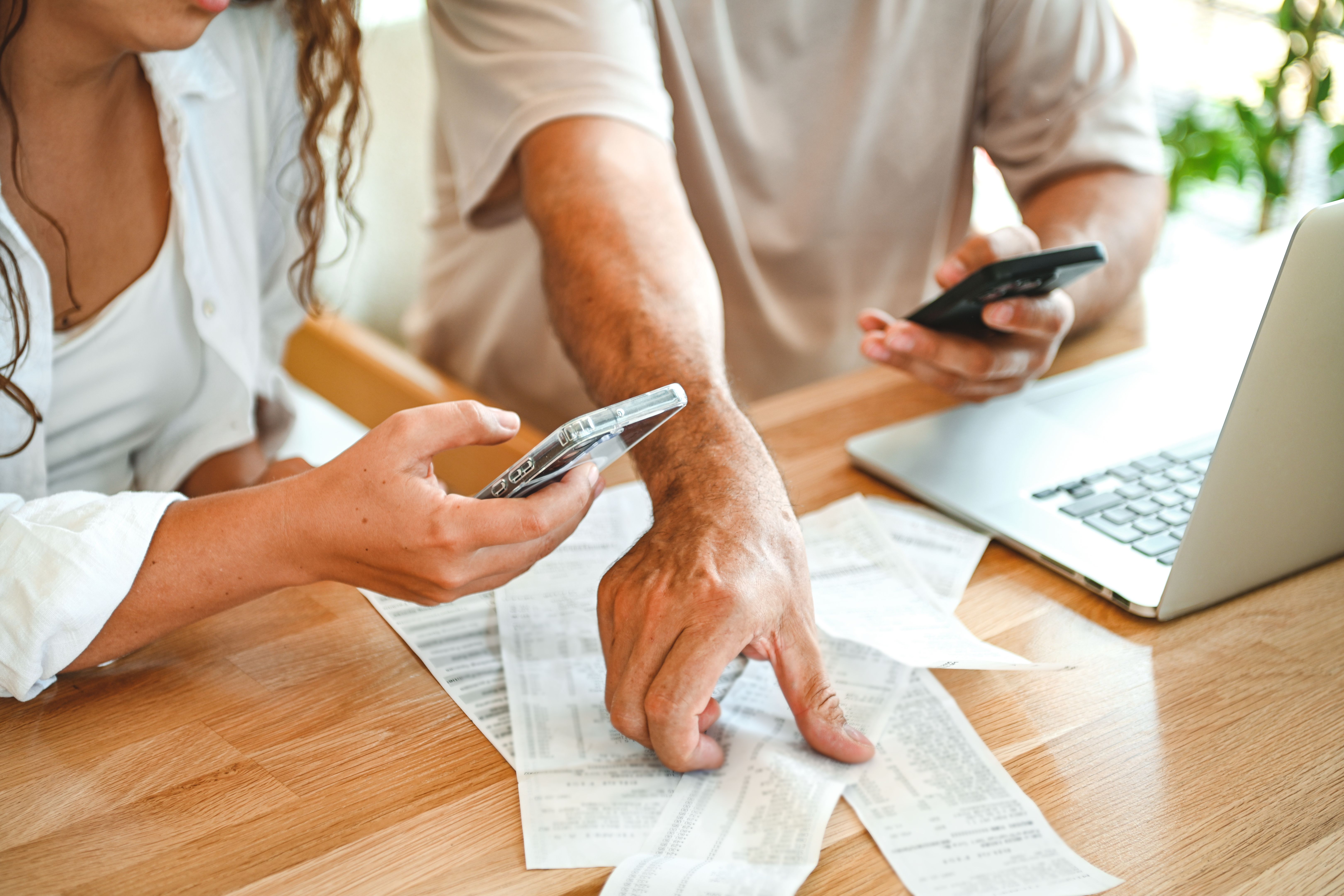 man and a woman are calculating a budget