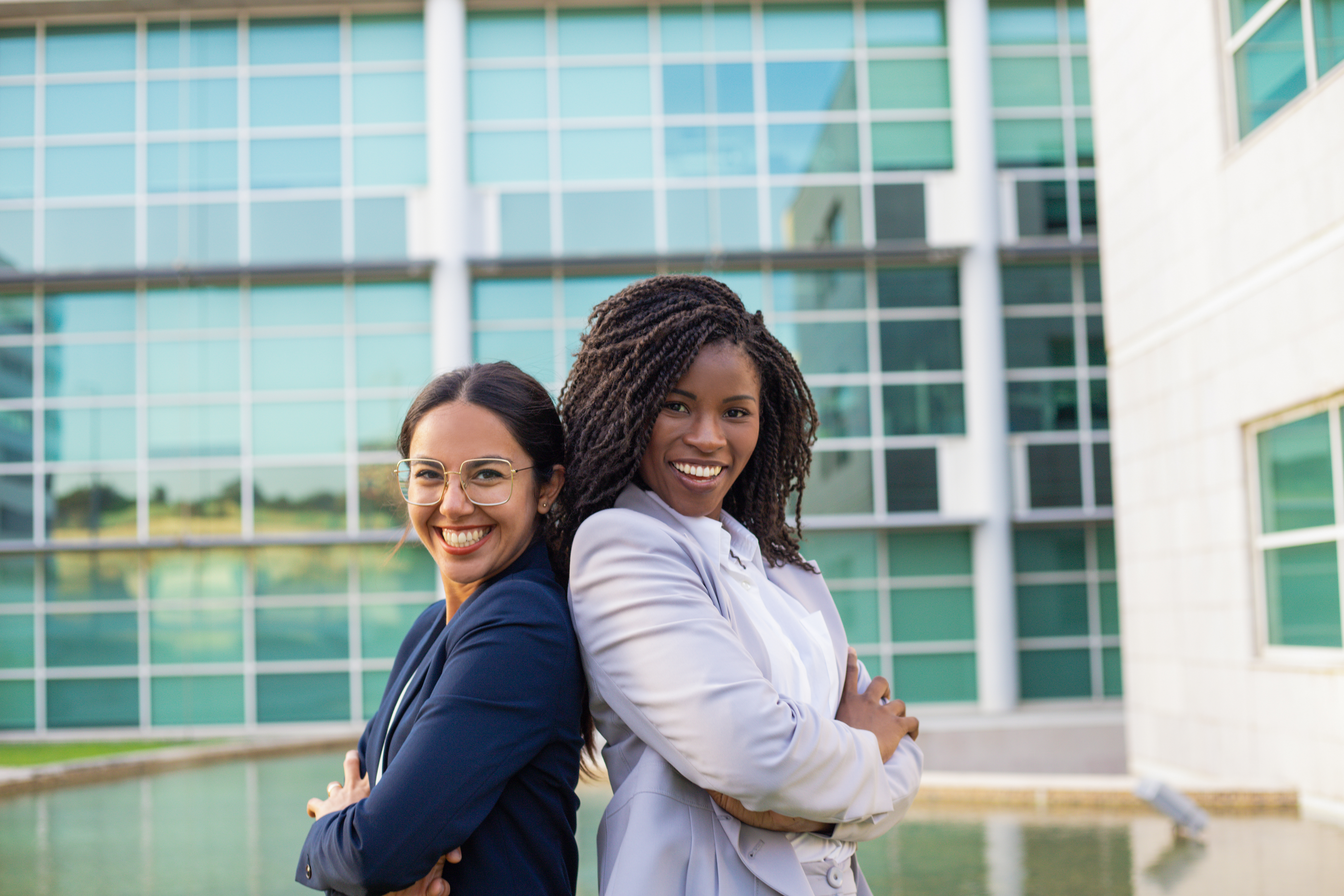 Happy joyful businesswomen posing outside Happy joyful businesswomen posing outside