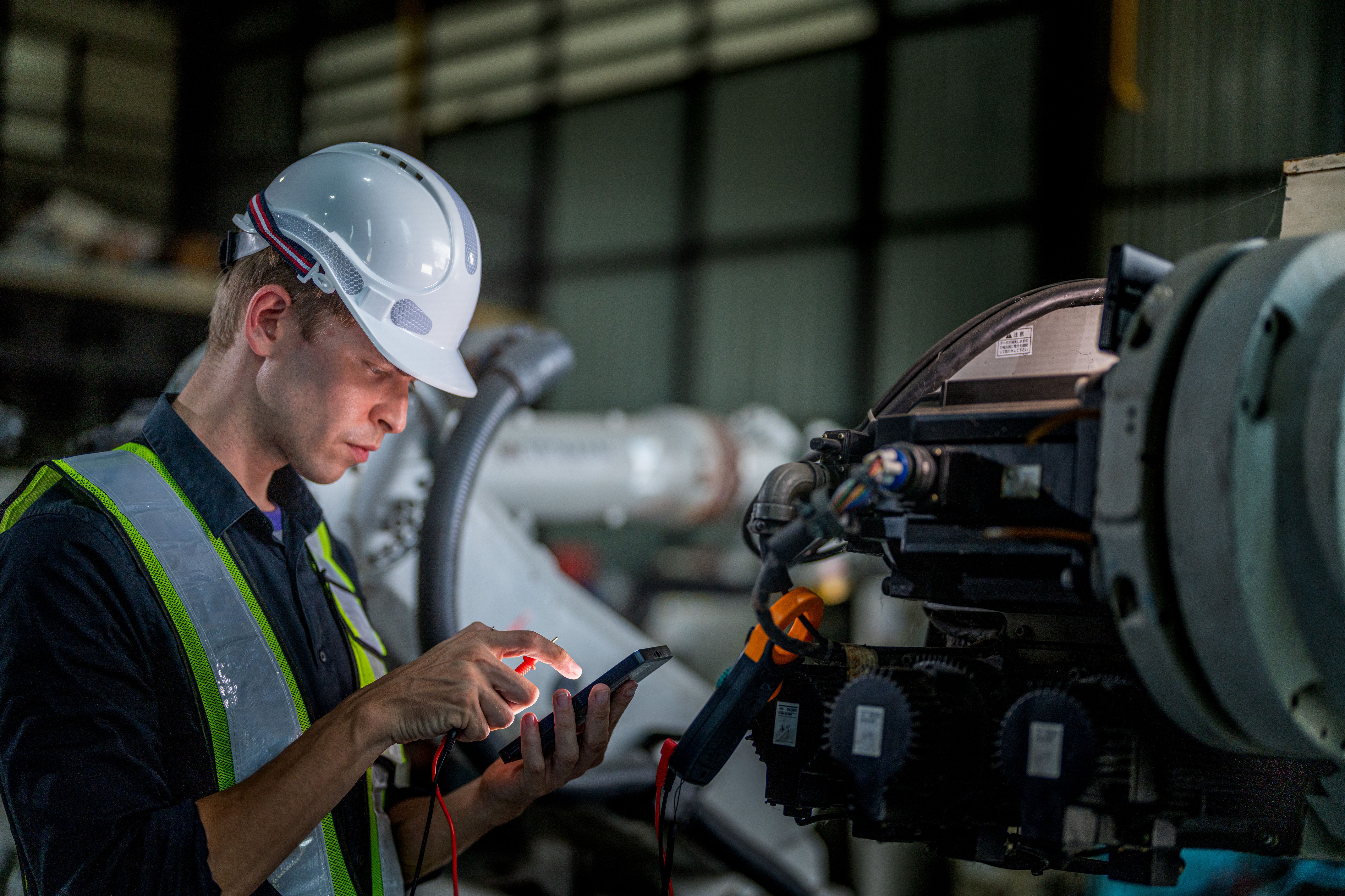 Engineer checking a machine on the production floor