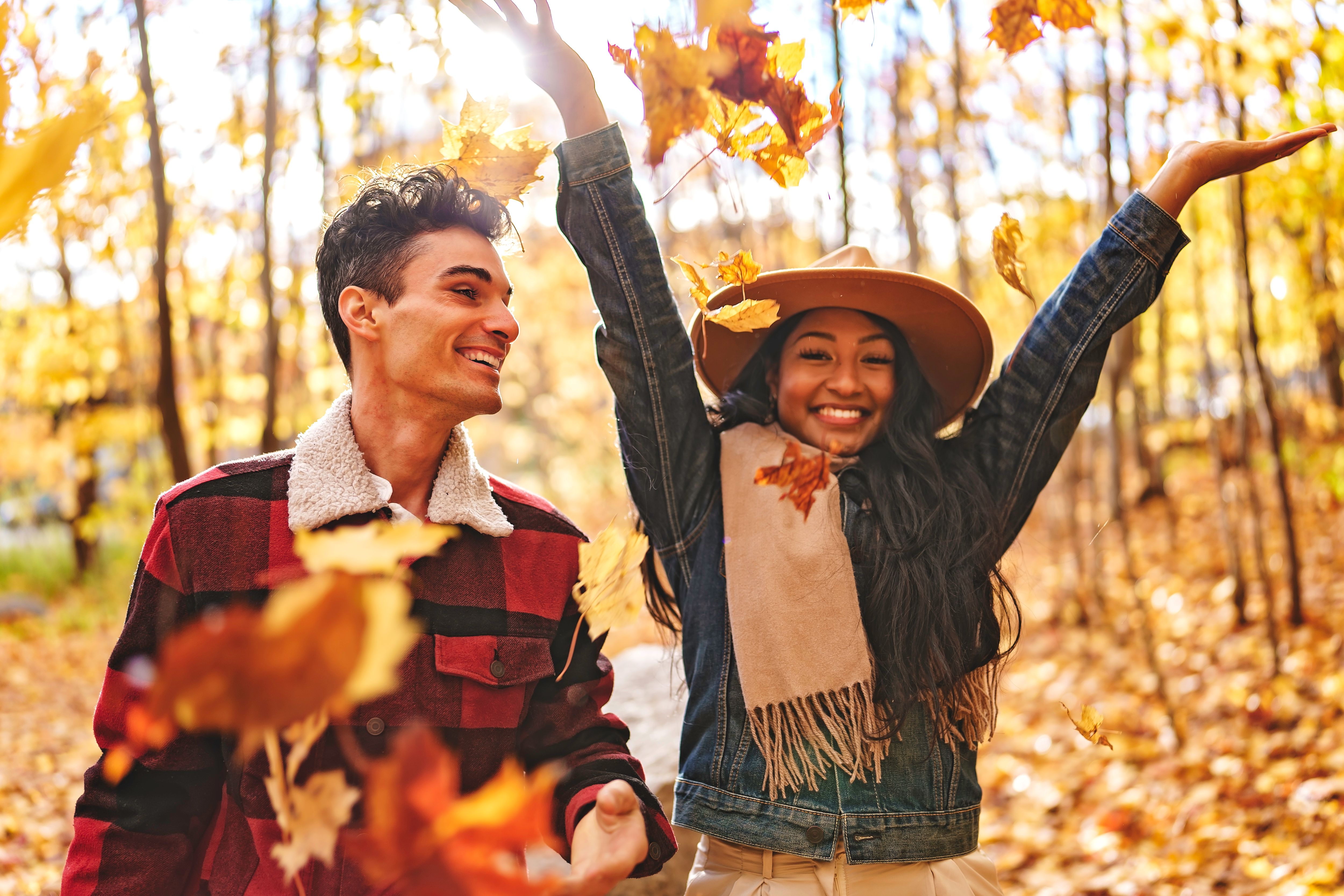 Young beautiful couple in the autumn garden at fall.