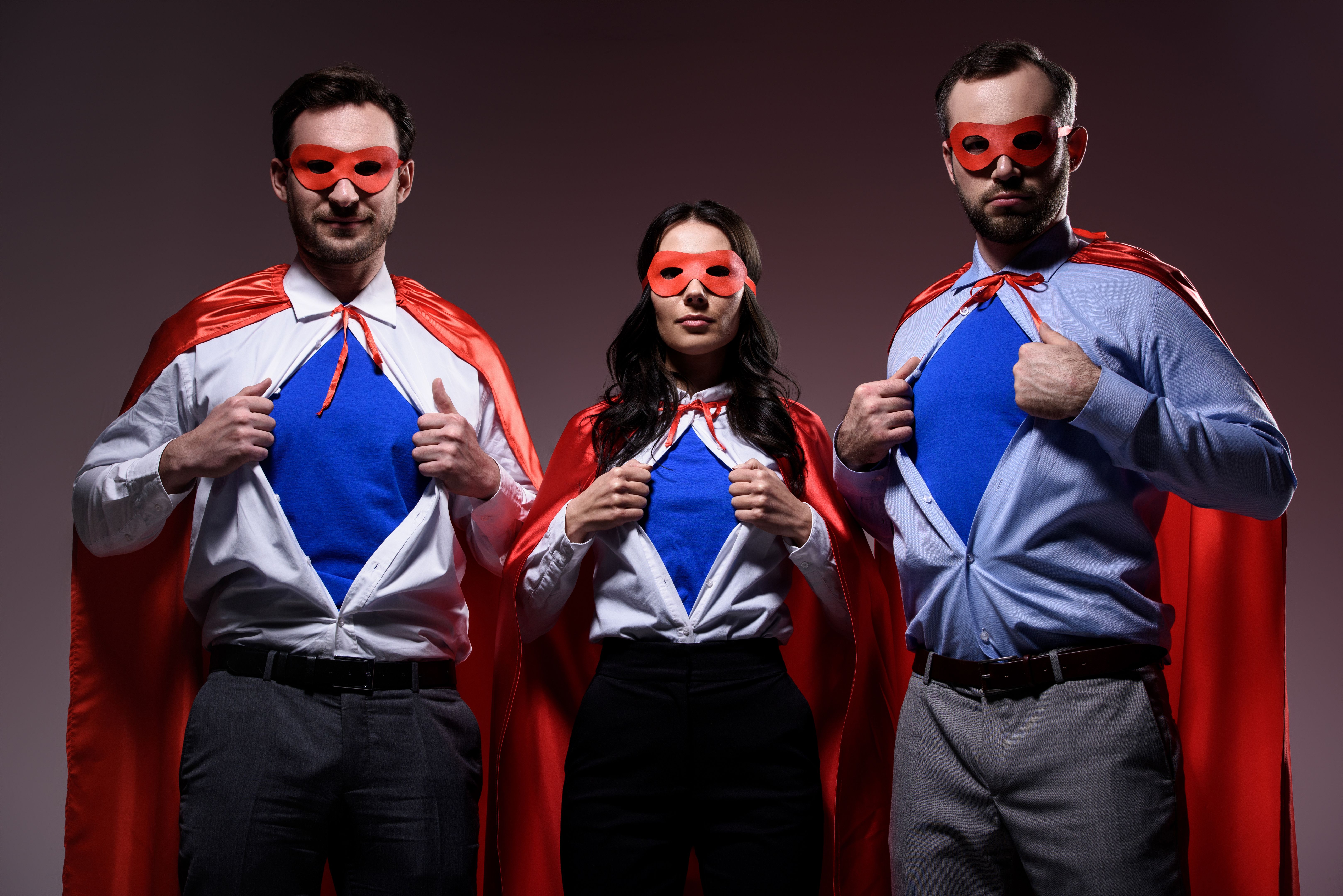 super businesspeople in masks and capes showing blue shirts isolated on grey