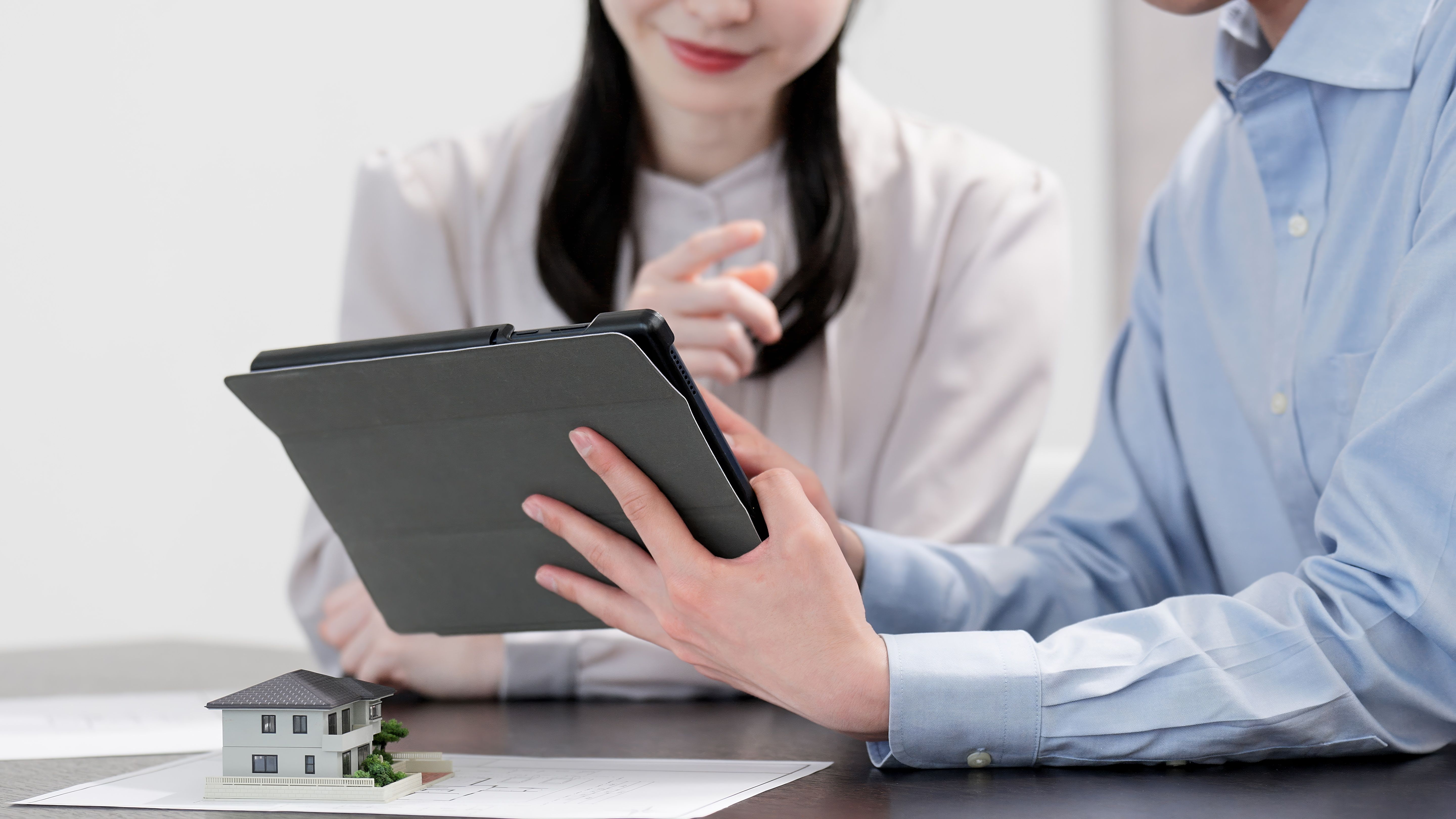 Men and women looking at real estate information on a tablet