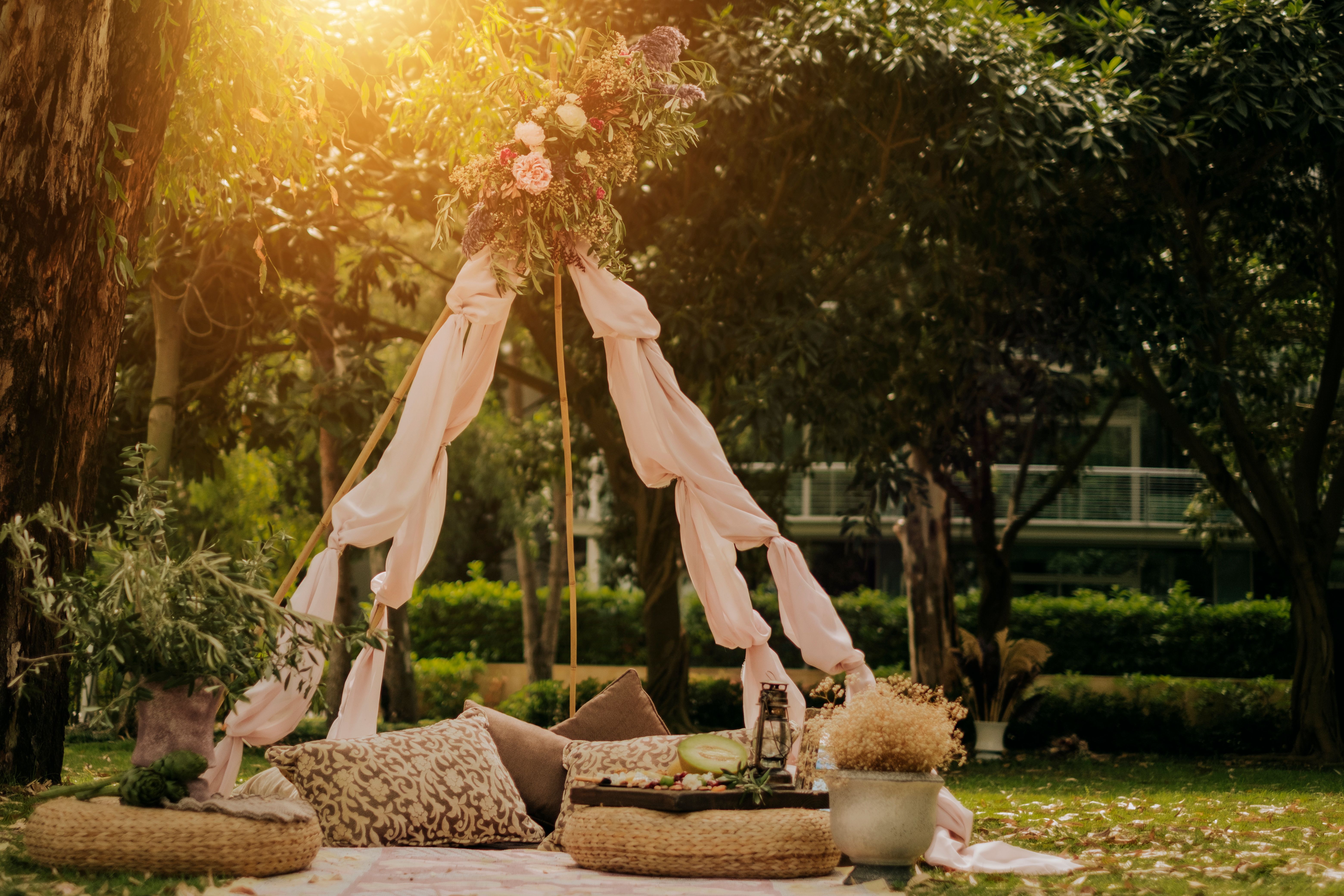 Beautiful summer picnic on the beach at sunset in zero waste style. Eco friendly idea for weekend staycations