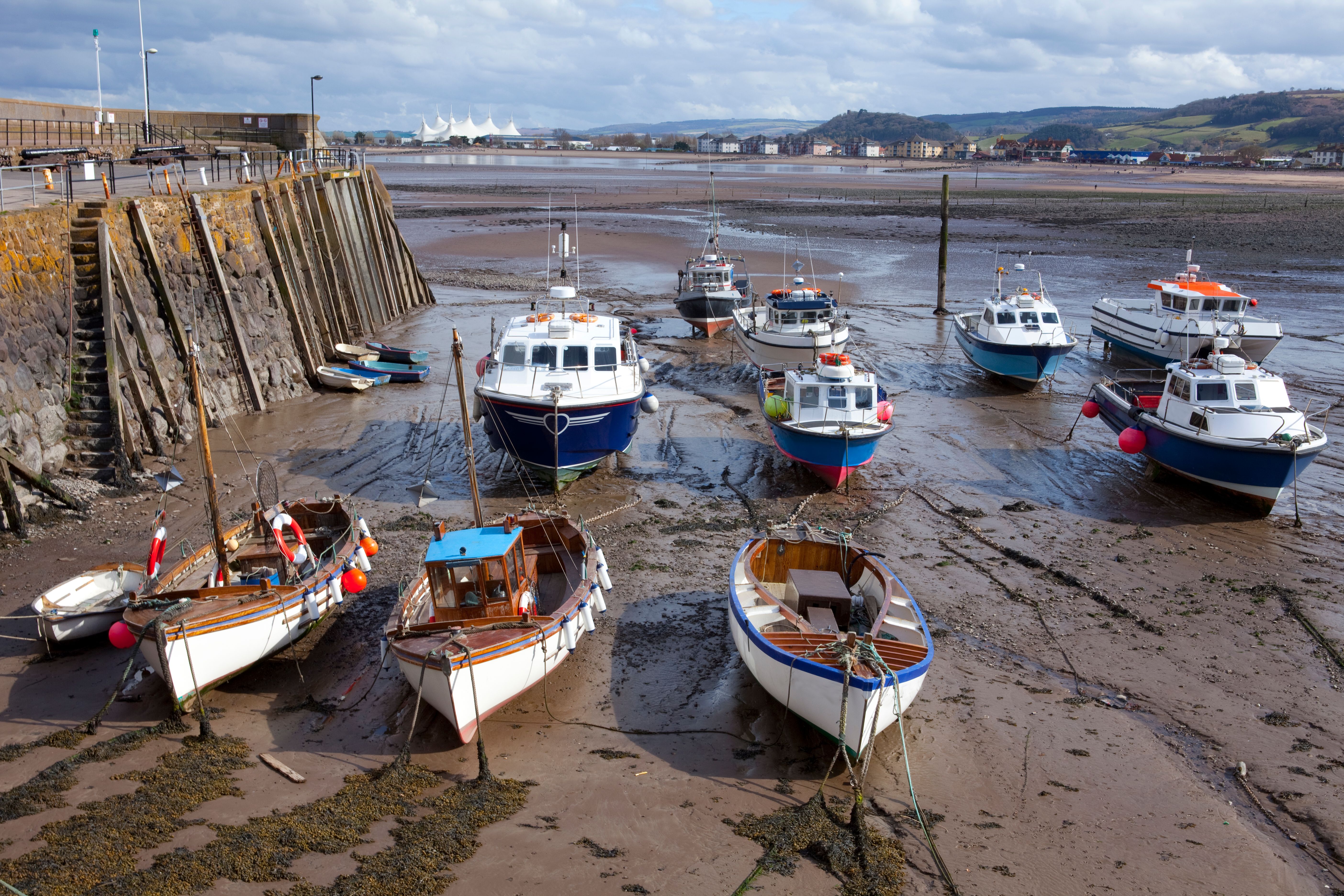 Fishing boats at Low Tide at Minehead Harbour with Butlins in the Distance Fishing boats at Low Tide at Minehead Harbour with Butlins in the Distance