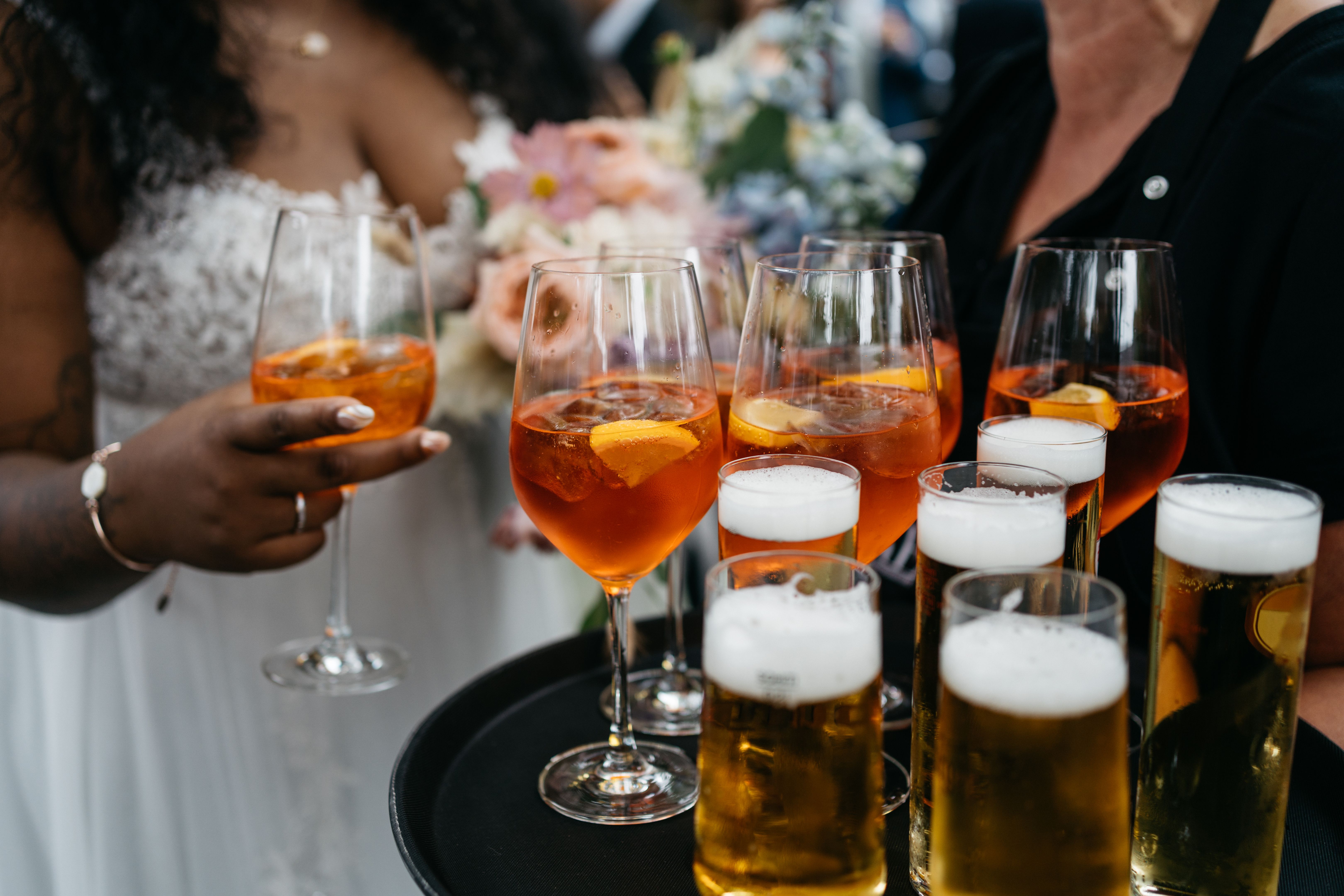 waitress is serving longdrinks and beer to the bride at a wedding