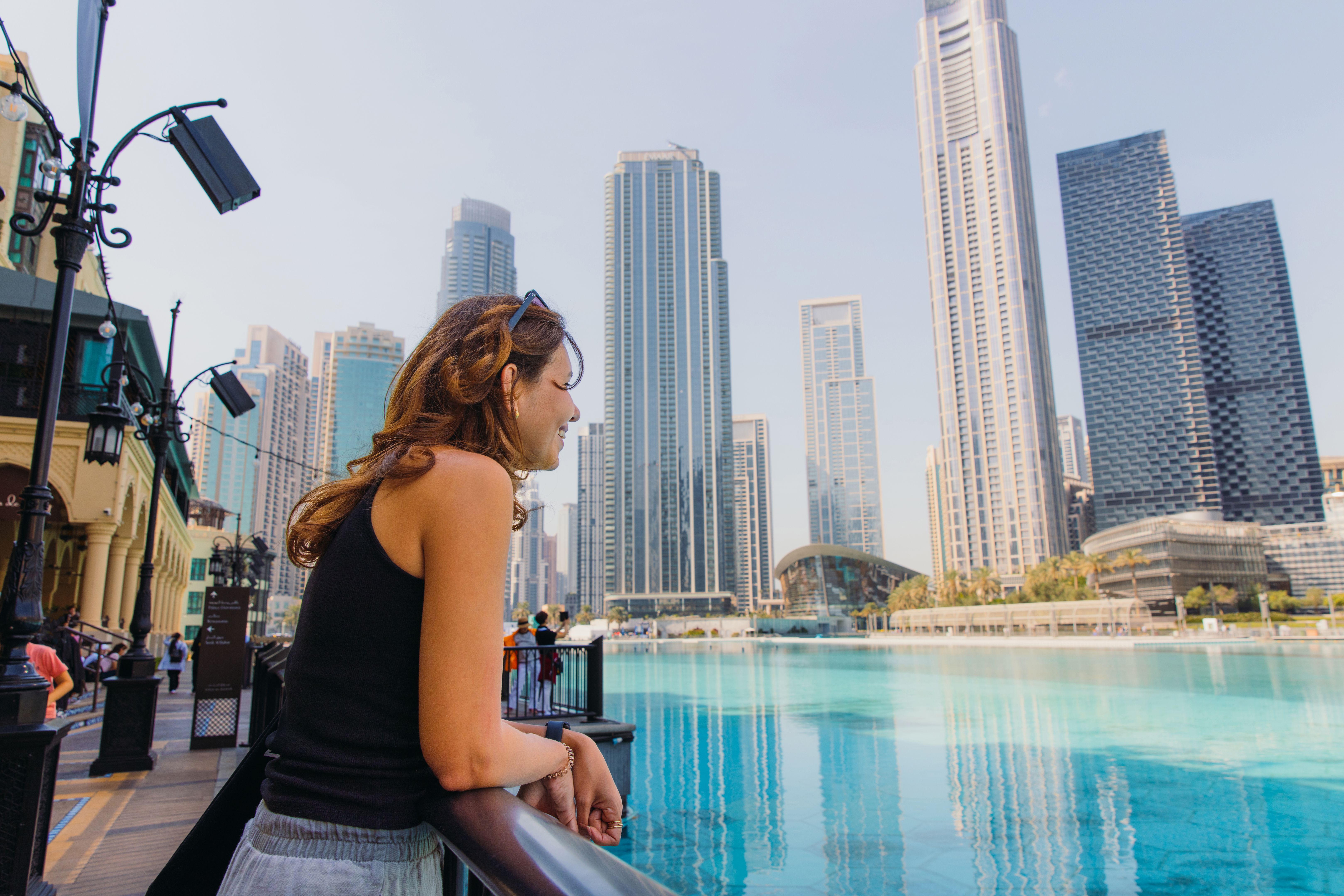 Middle Eastern Woman Contemplating Scenic View of Dubai Downtown Cityscape