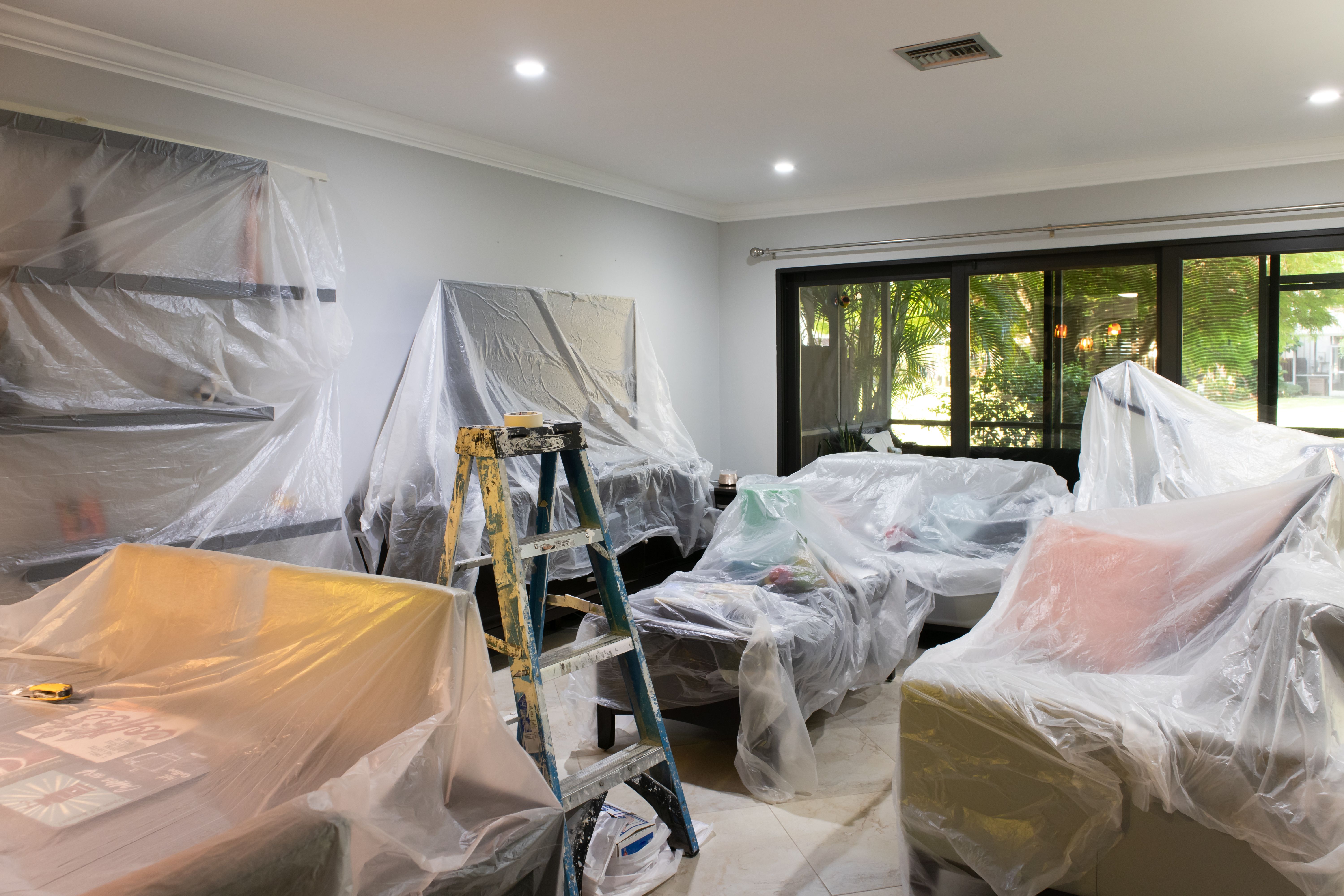 living room covered with plastic for painting