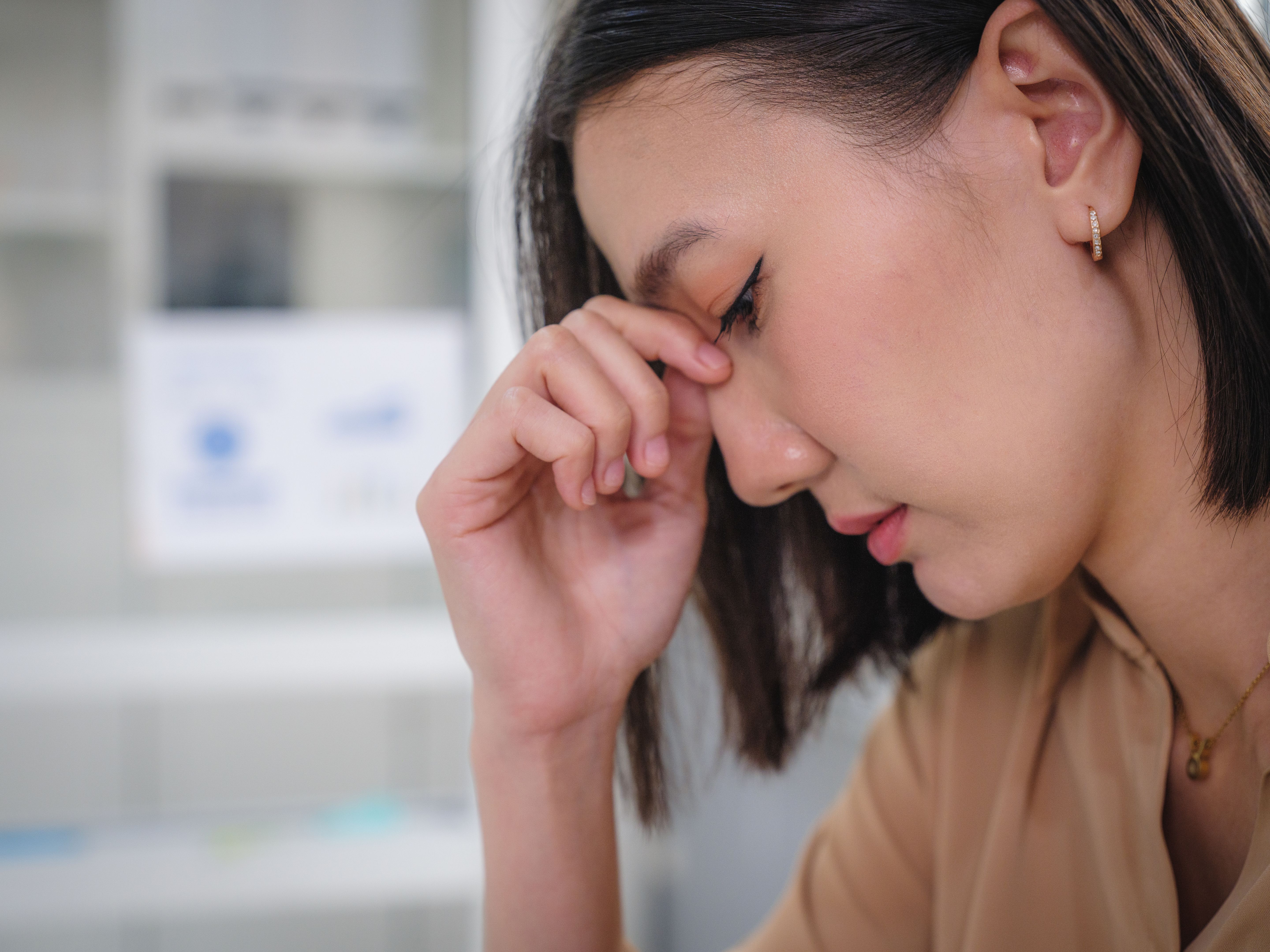 Portrait of upset Asian businesswomen feel strain or tired from her work