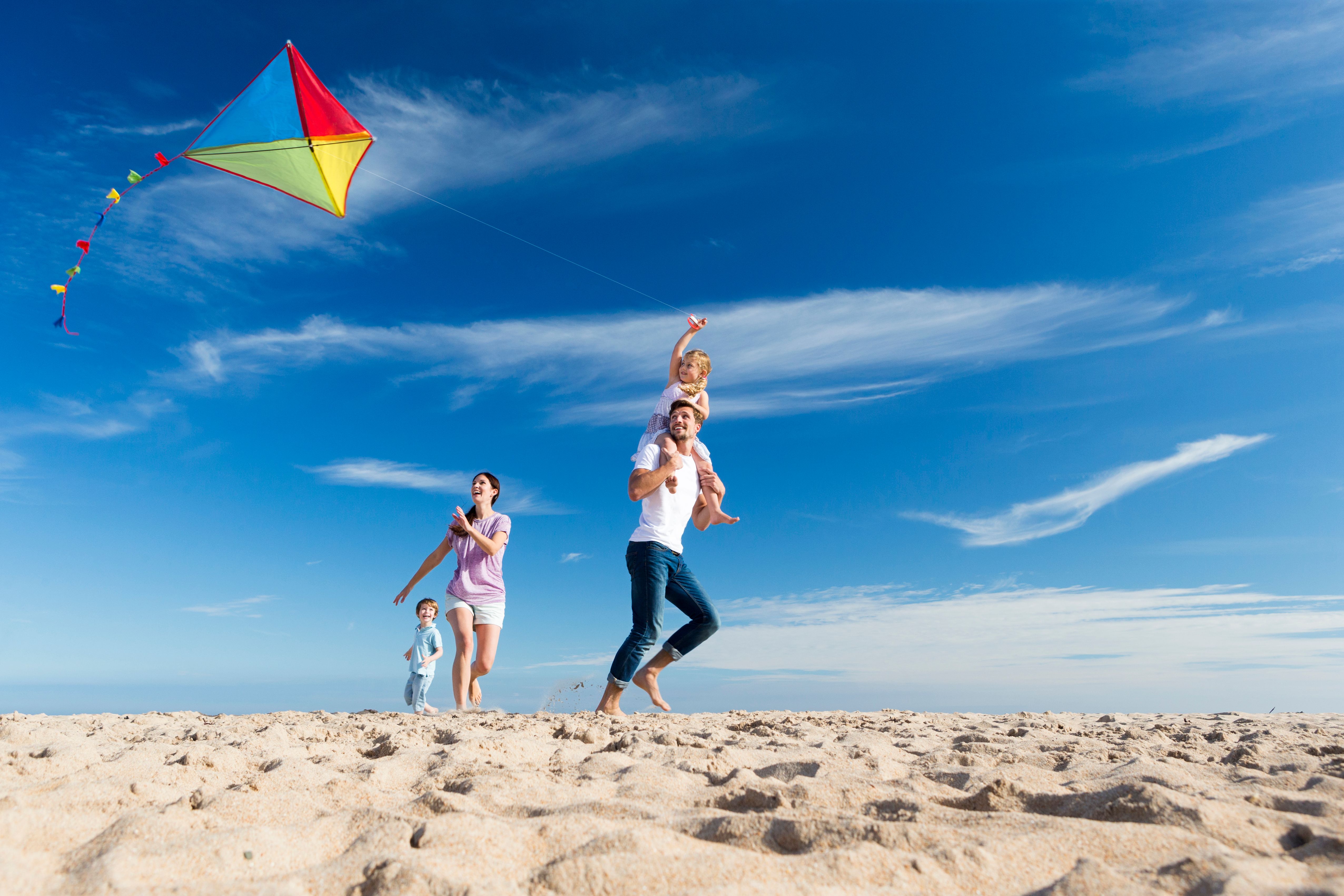 Family on the Beach Flting a Kite