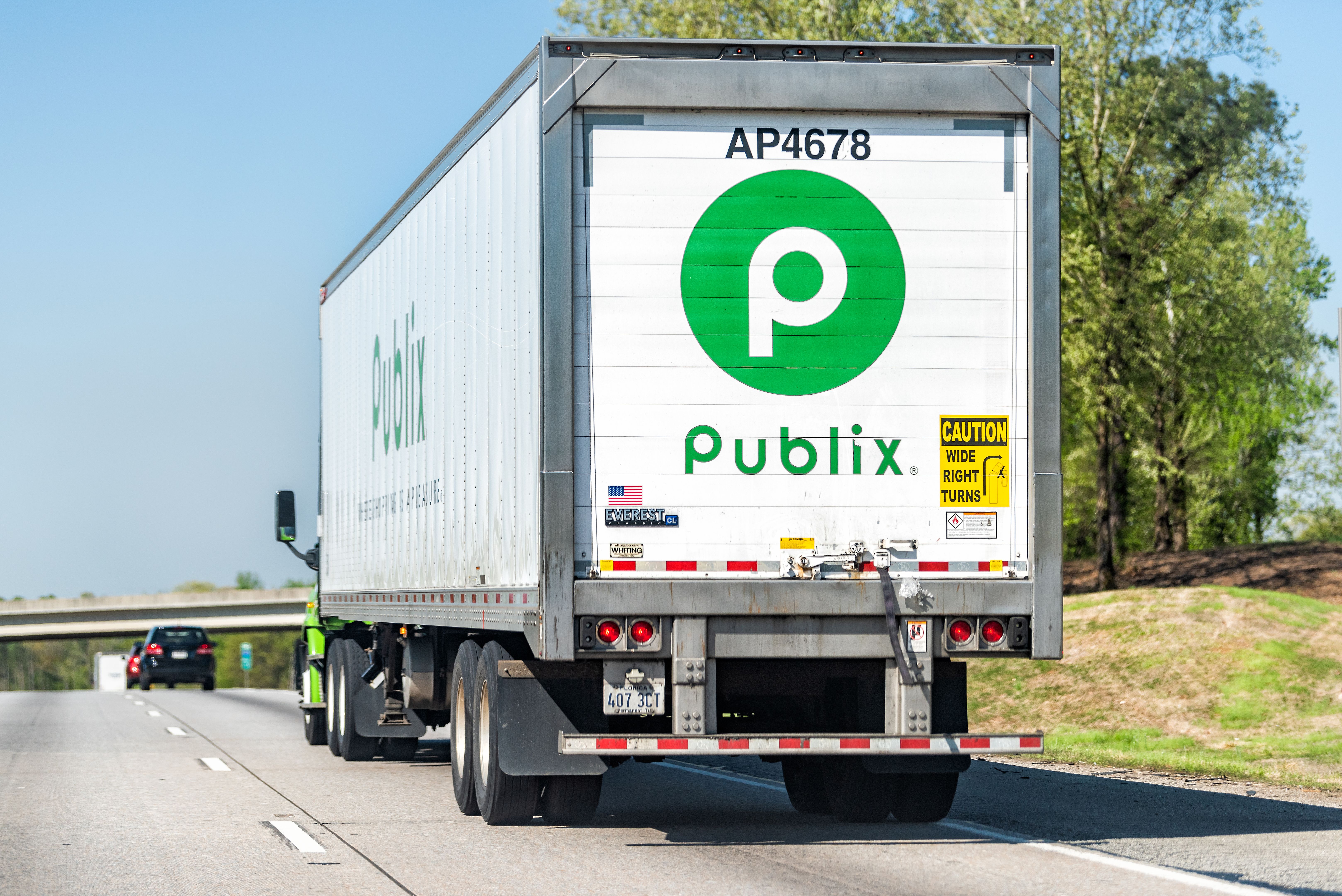 Back of Publix grocery store delivery truck closeup on highway road with green sign