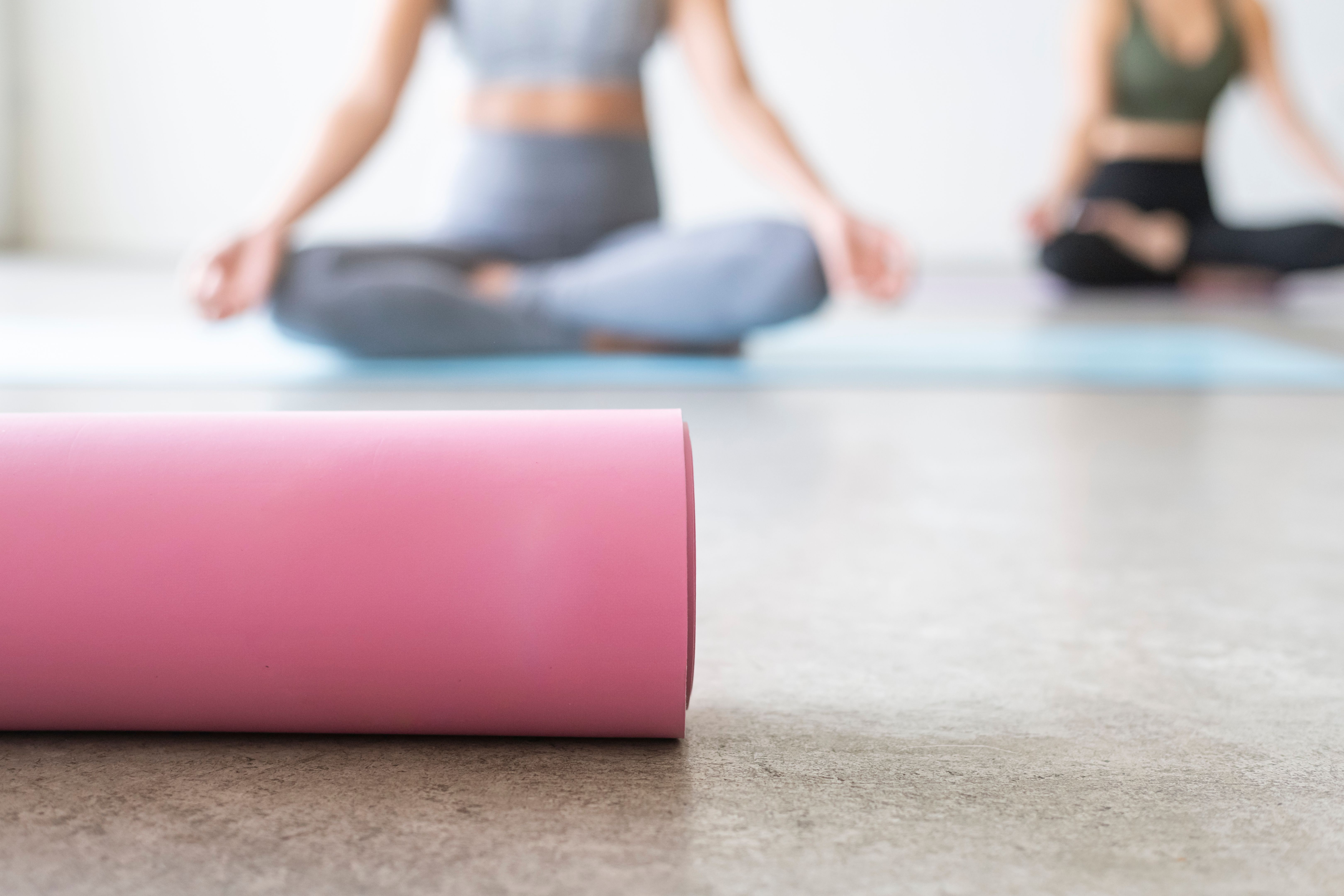 Athletic women meditating in yoga class