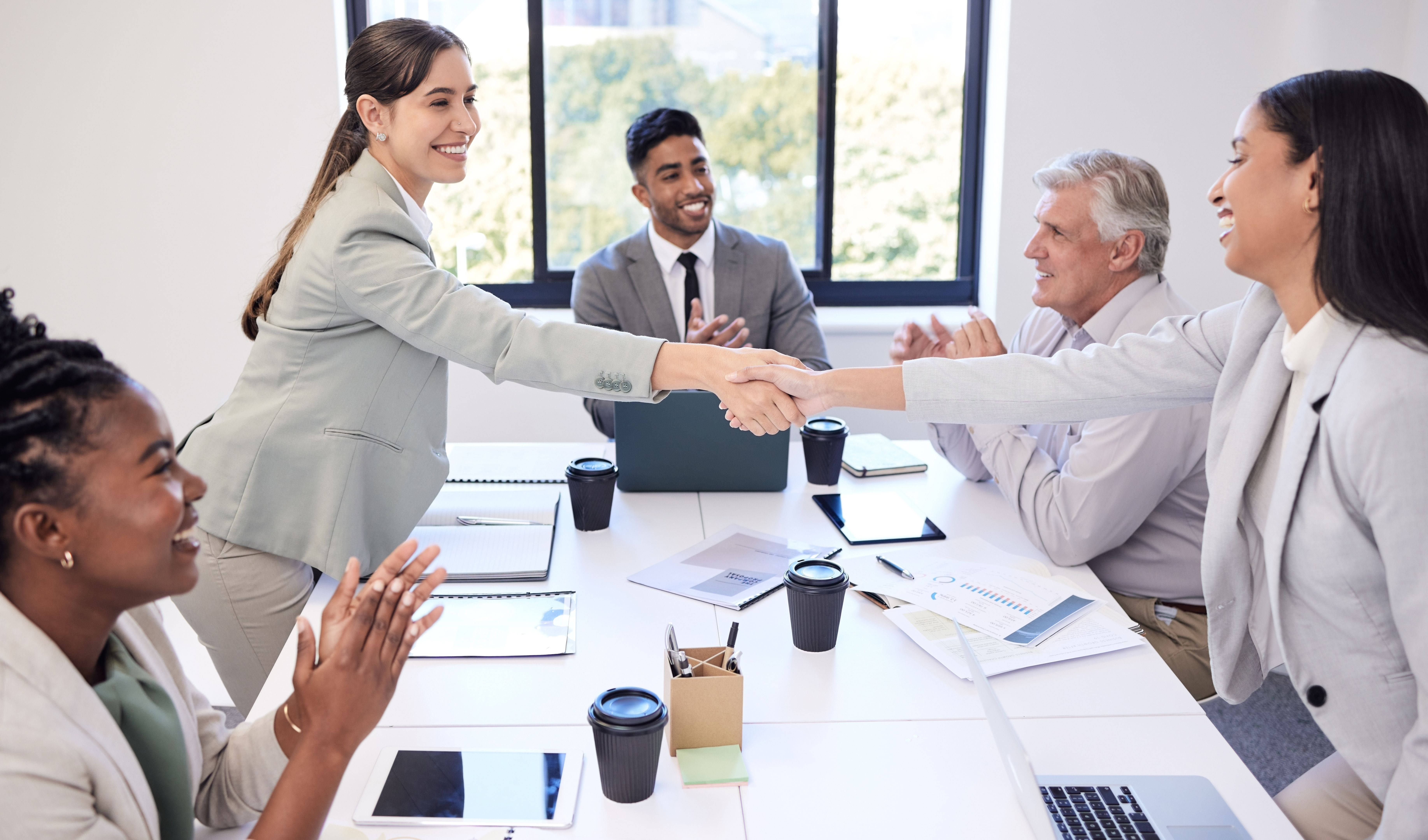 Shot of businesspeople shaking hands during a meeting in an office