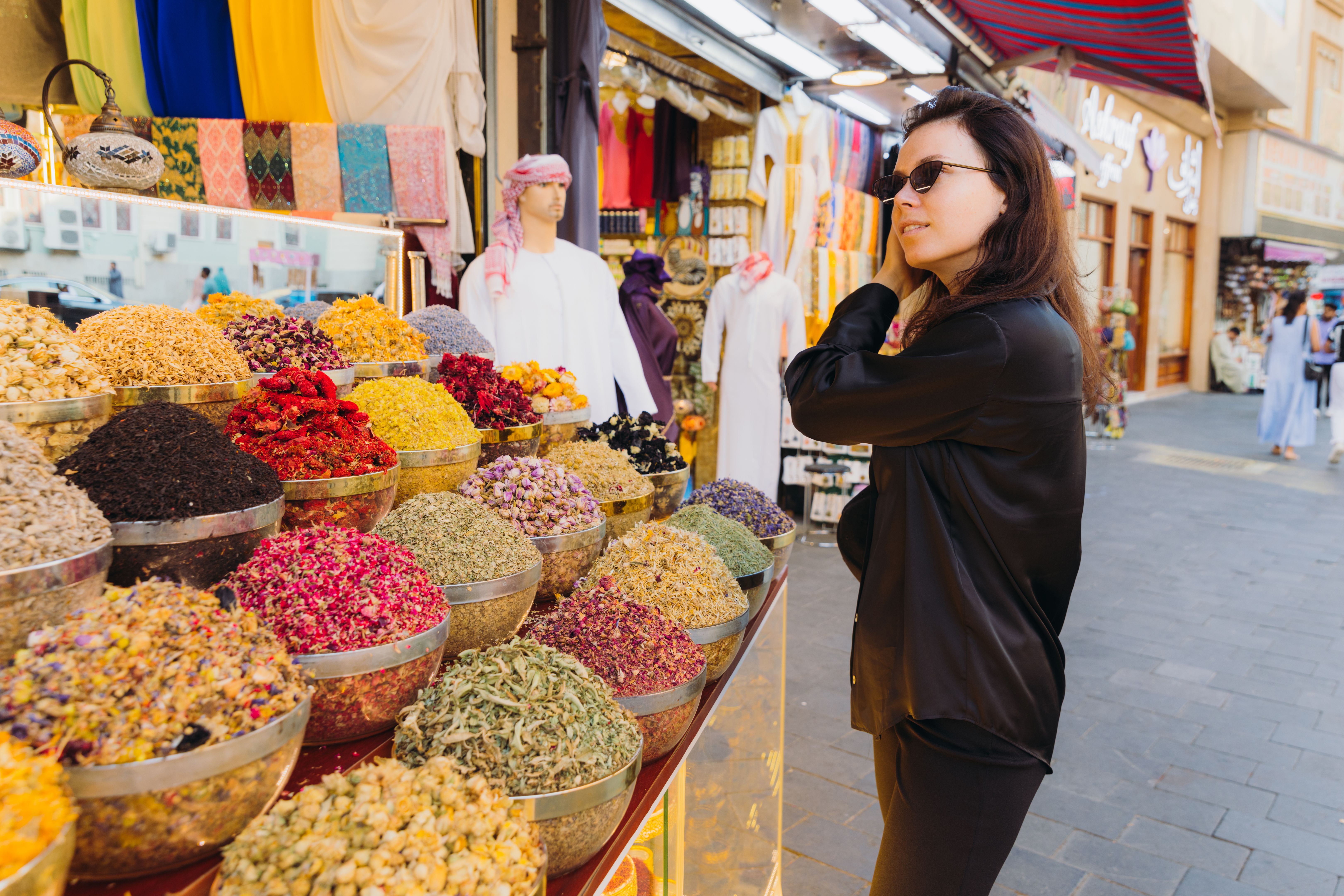Woman Shopping at Spice and Dyes Market in Dubai City