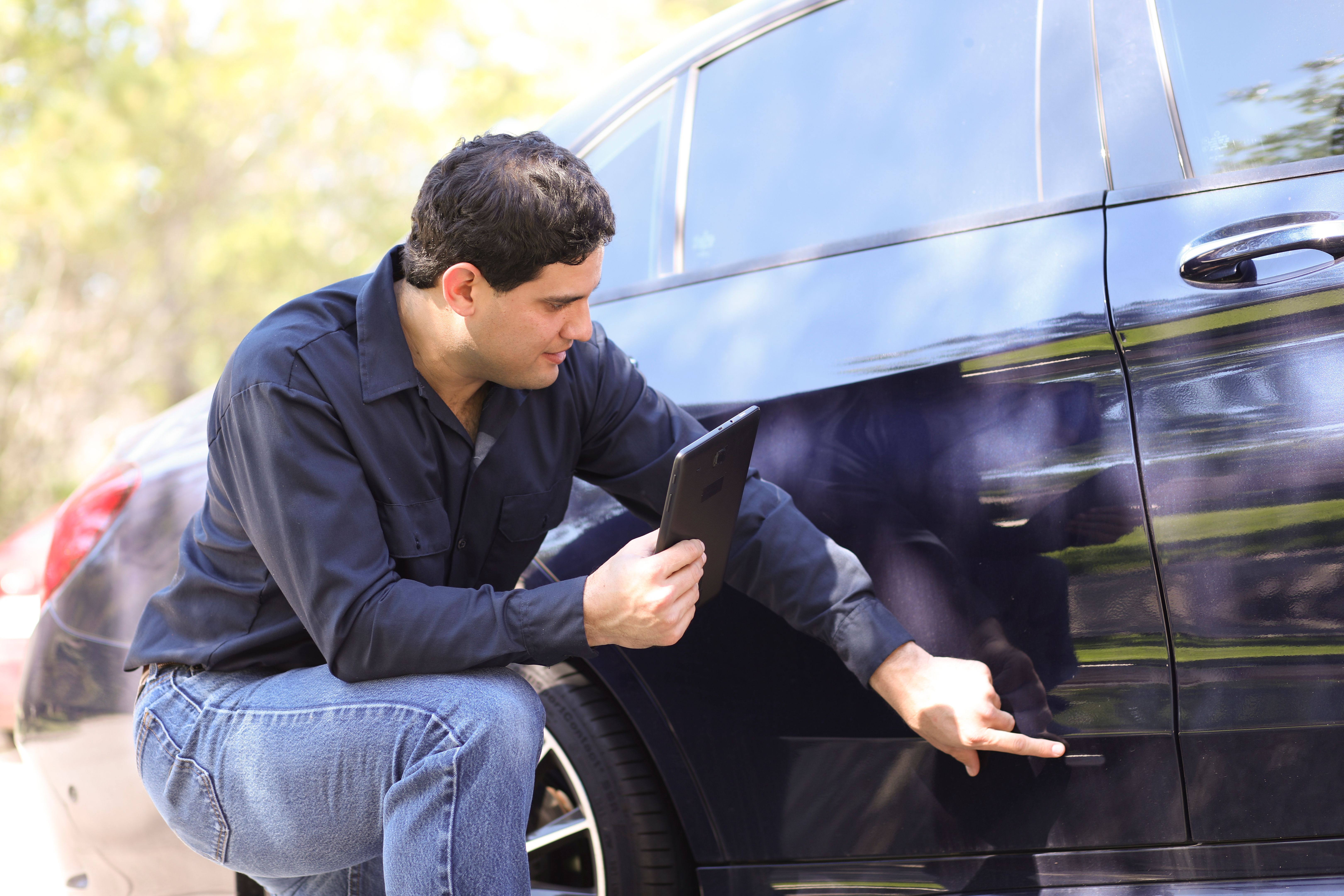 mechanic assessing car