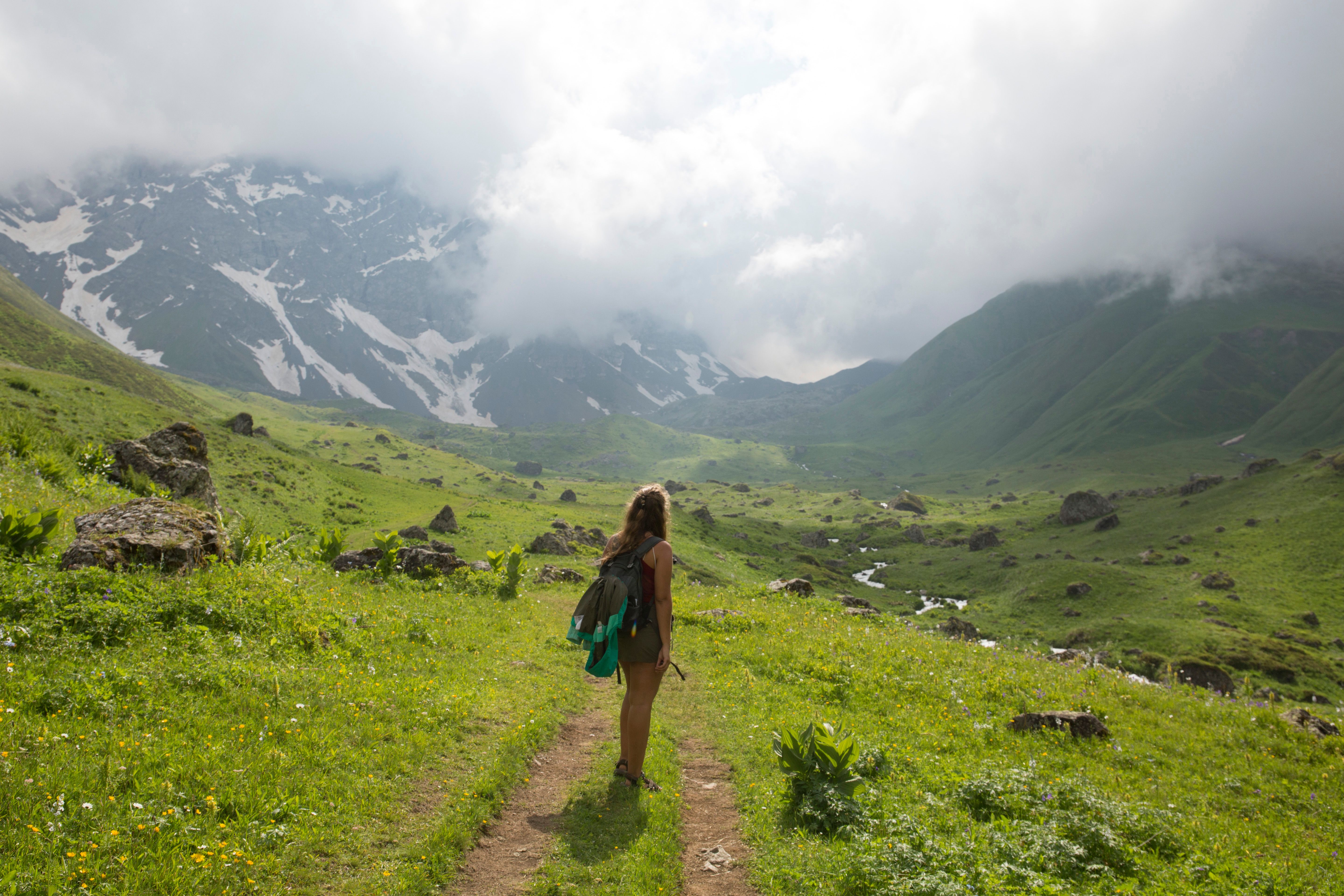 Young woman explores Caucasus mountains