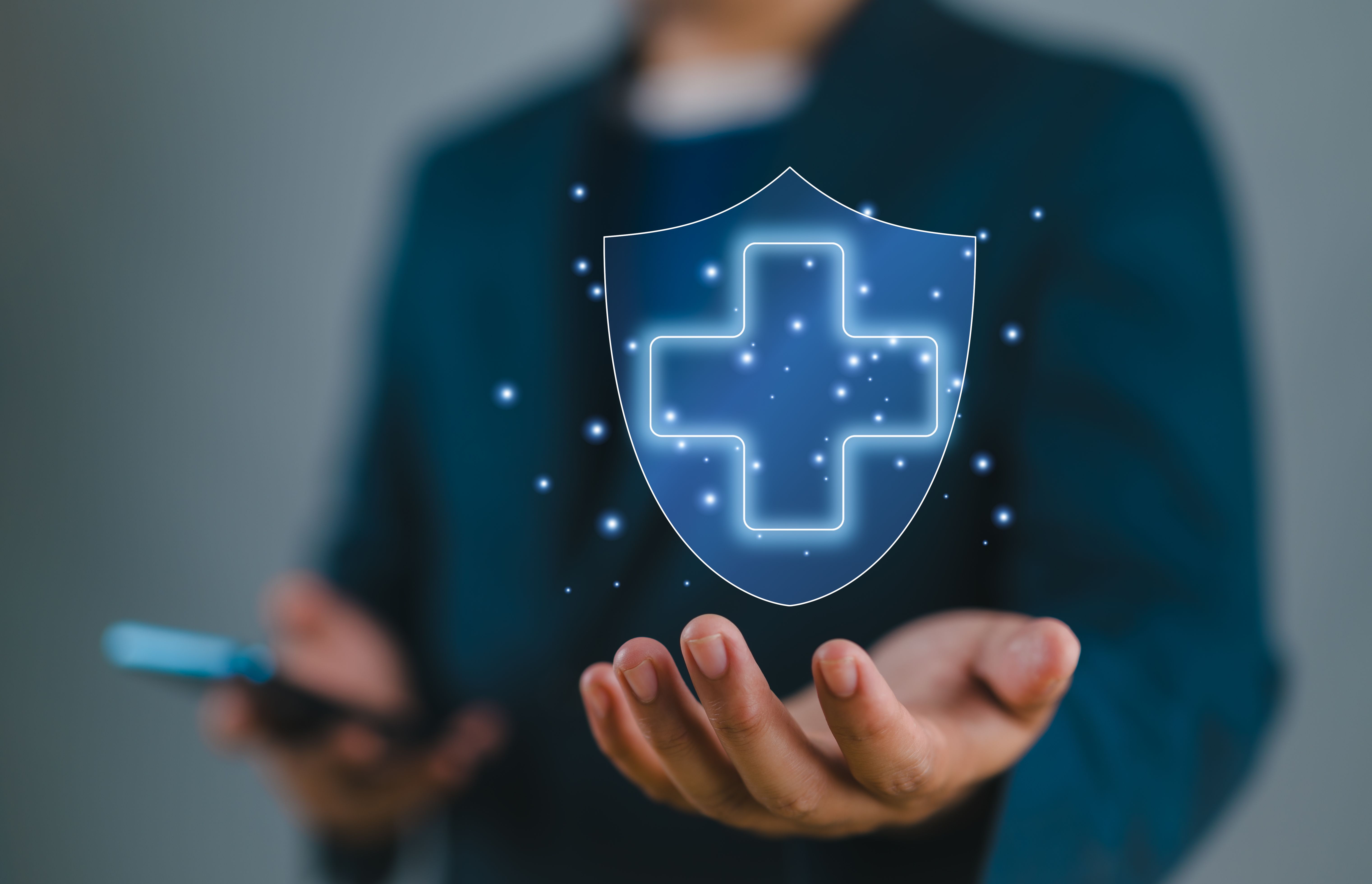 Businessman holding virtual protect health and insurance sign with copy space.