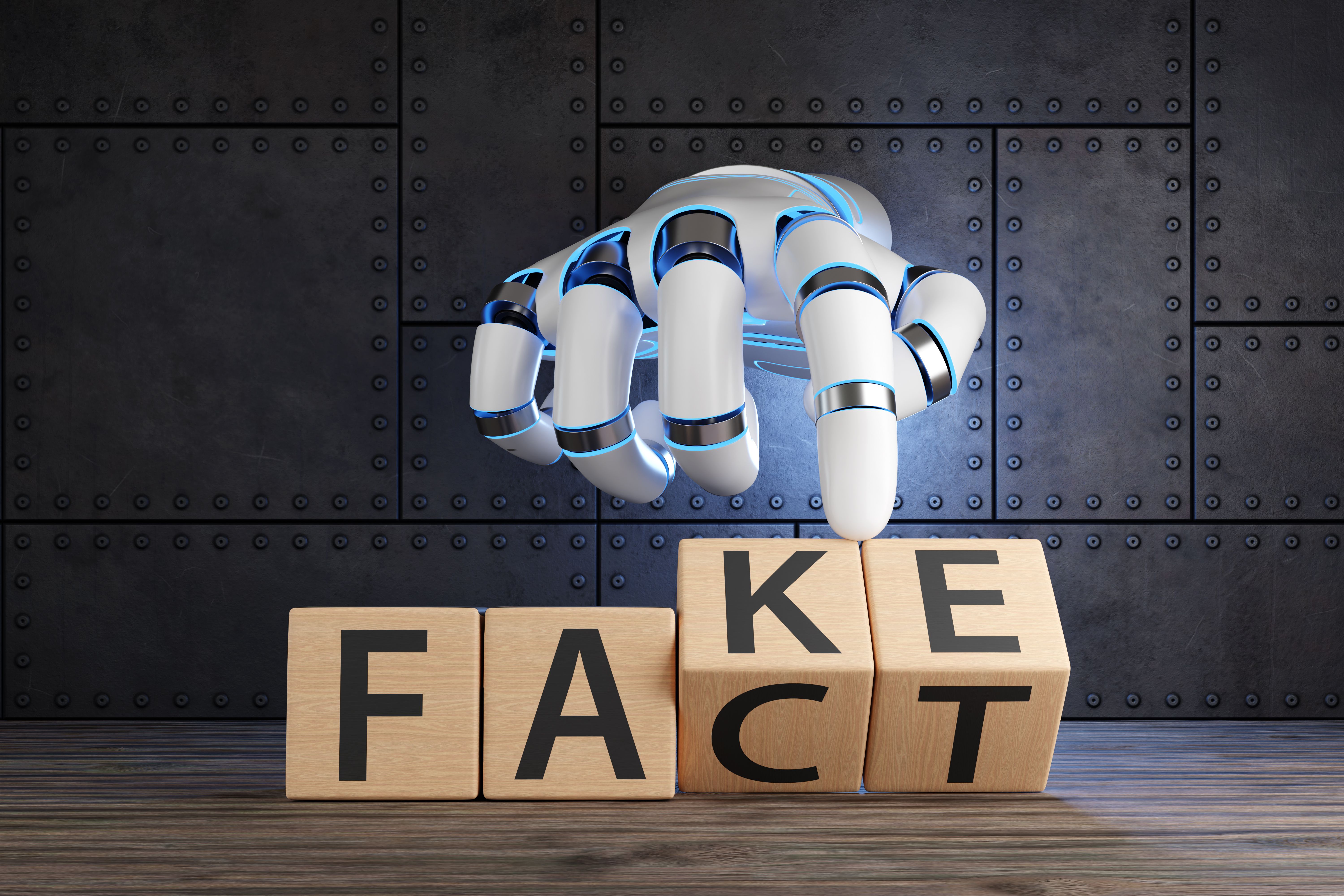 White robotic hand turning 2 wooden blocks revealing the words FACT and FAKE. Illustration of the concept of information accuracy of artificial intelligence and the fact check of AI content White robotic hand turning 2 wooden blocks revealing the words FACT and FAKE. Illustration of the concept of information accuracy of artificial intelligence and the fact check of AI content