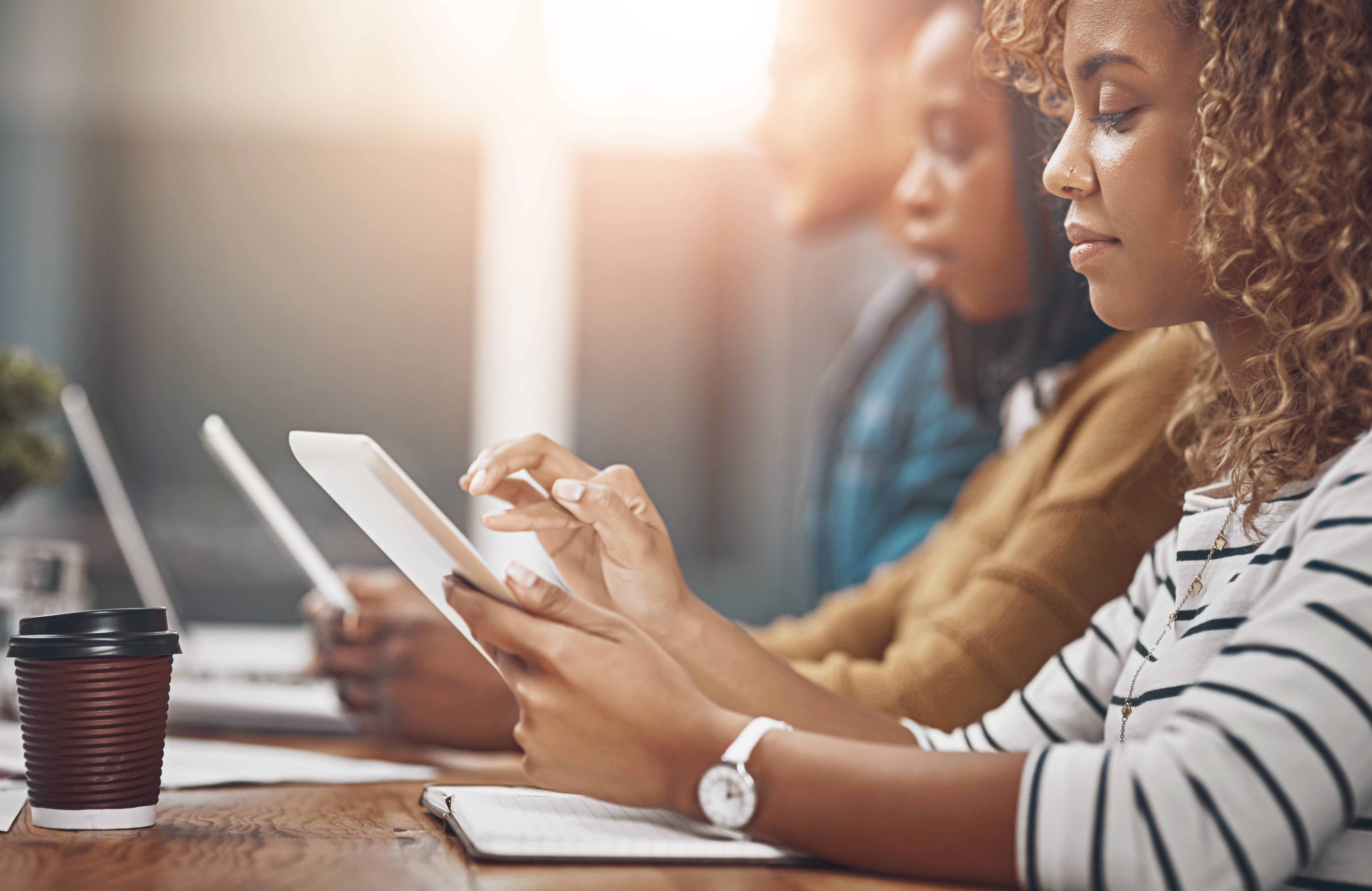Woman, tablet and business meeting with group in office as web developer in internship for company in workshop. Female person, tech and digital agency for skills, growth and career in brand design