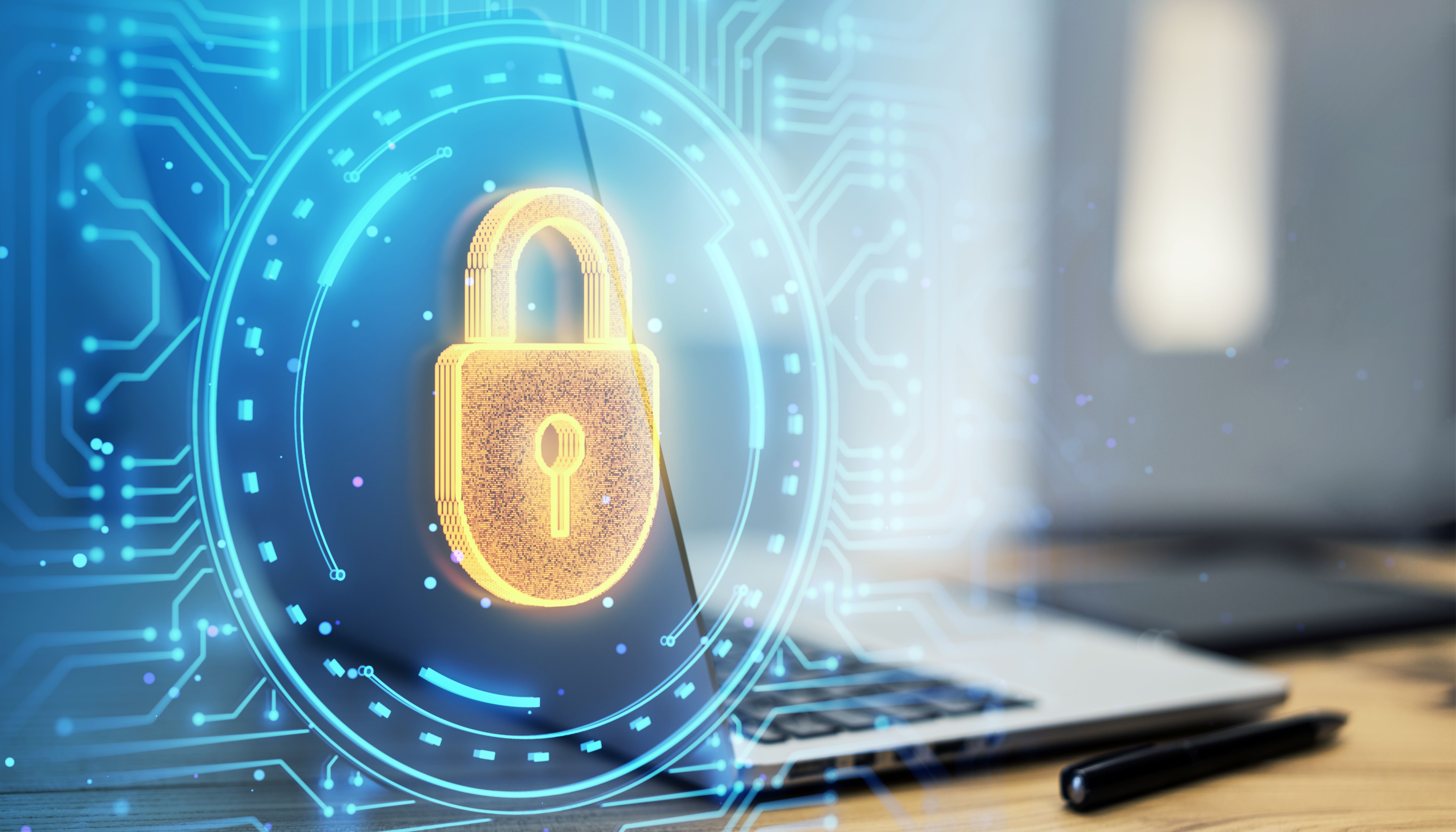 Digital padlock hologram overlaying a laptop on a desk, symbolizing cybersecurity and data protection. Digital padlock hologram overlaying a laptop on a desk, symbolizing cybersecurity and data protection.