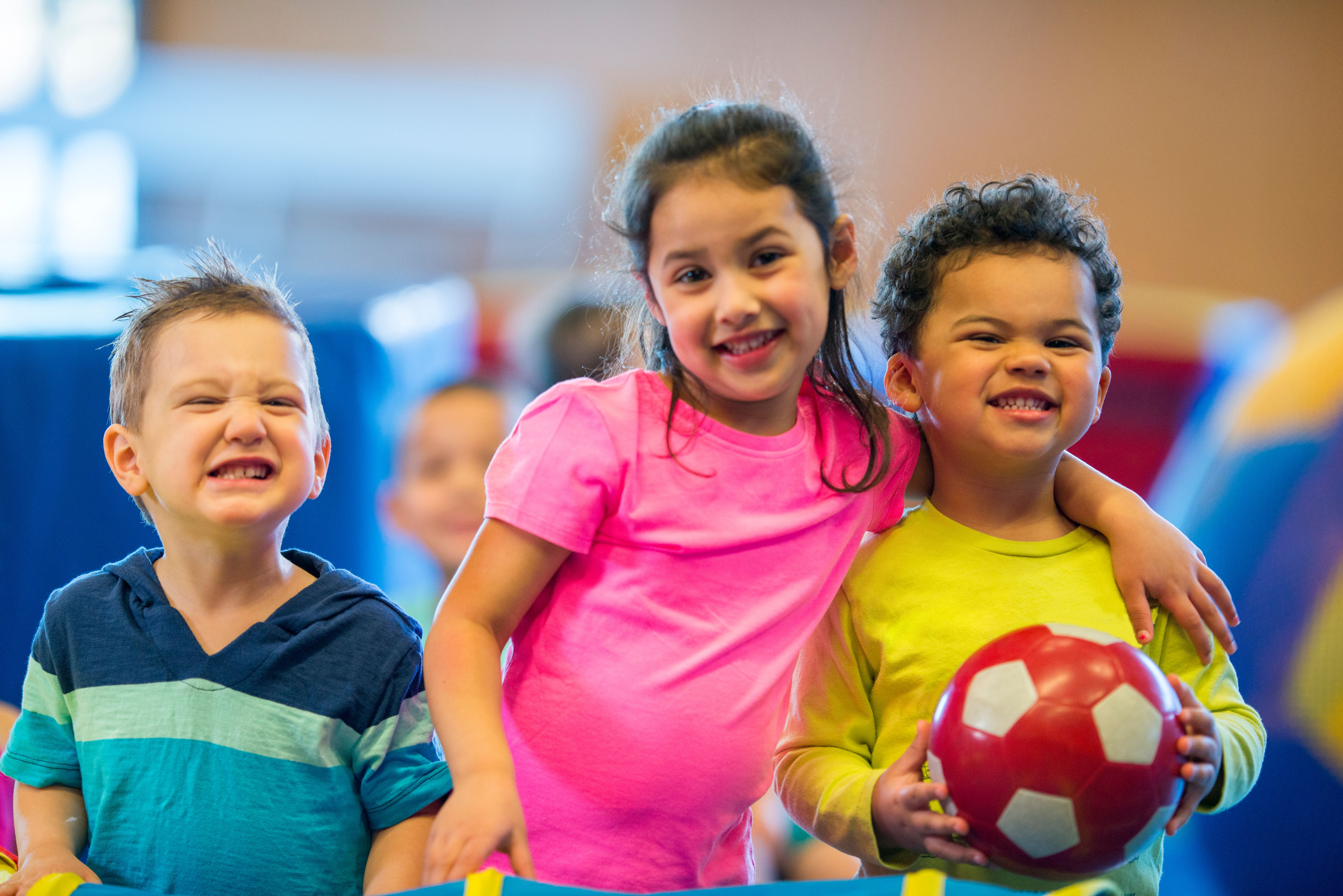 happy toddlers playing soccer