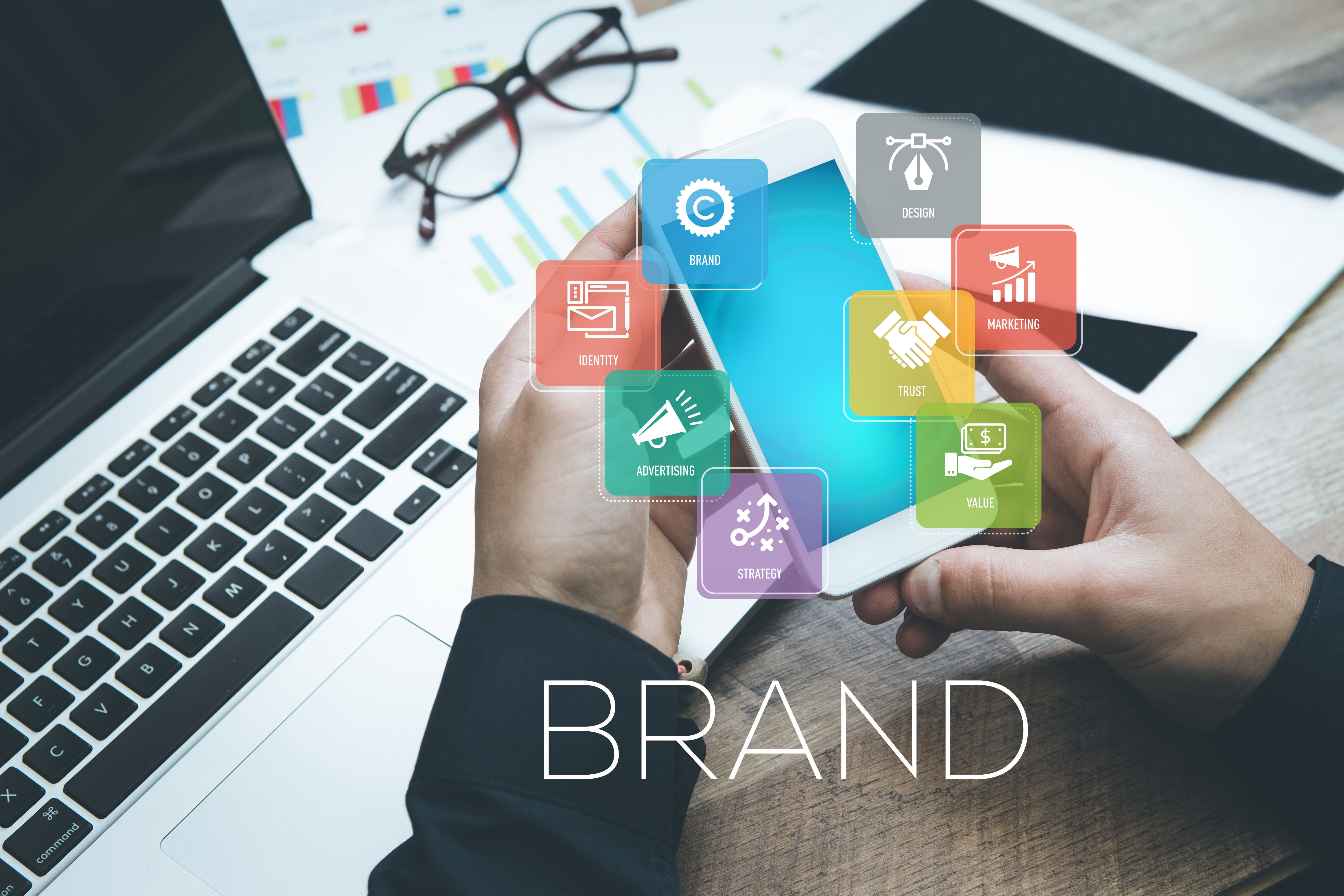 Hand holding smartphone and showing Brand concept Hand holding smartphone and showing Brand concept