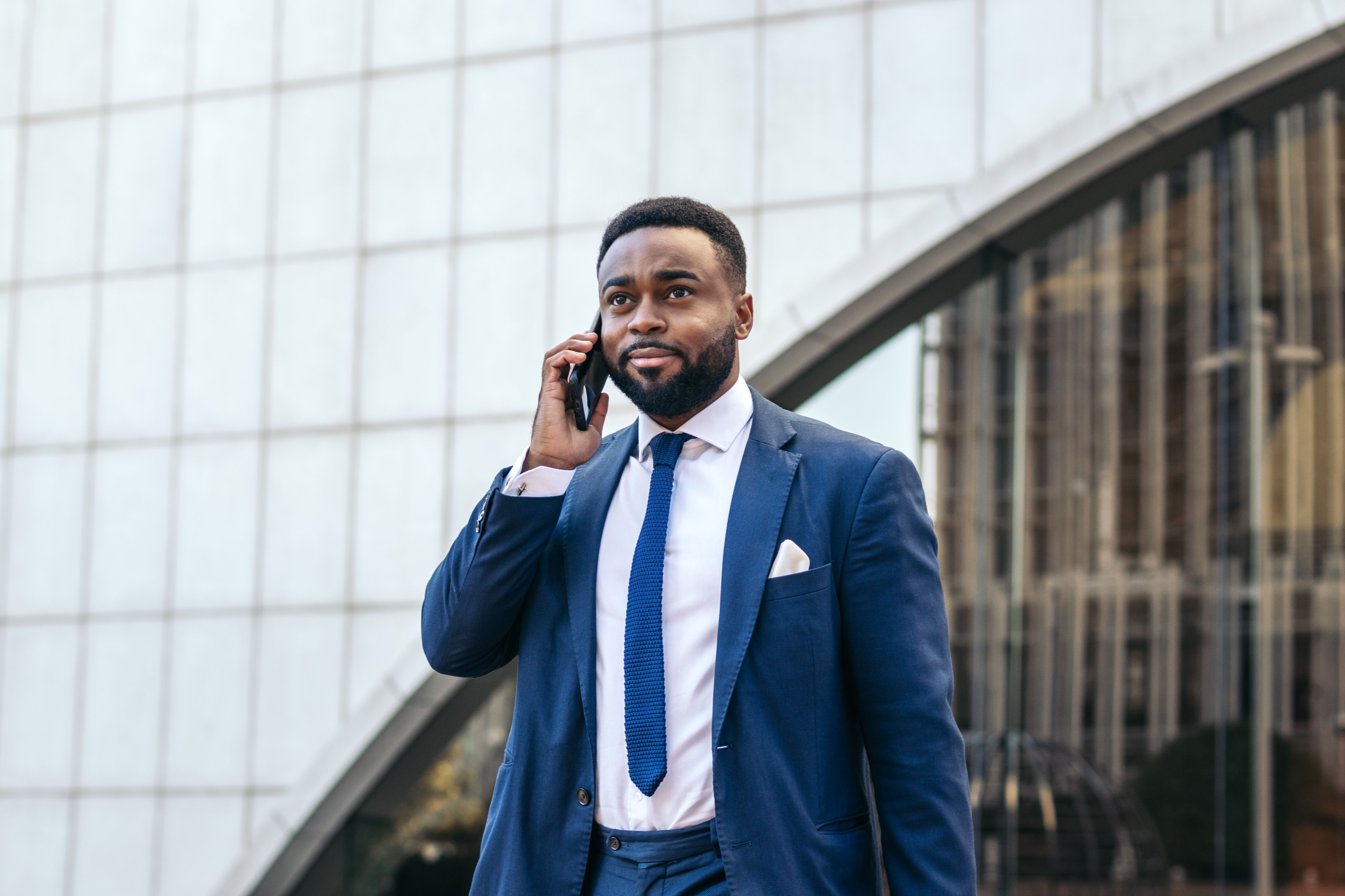 Business black man in suit talking on the phone