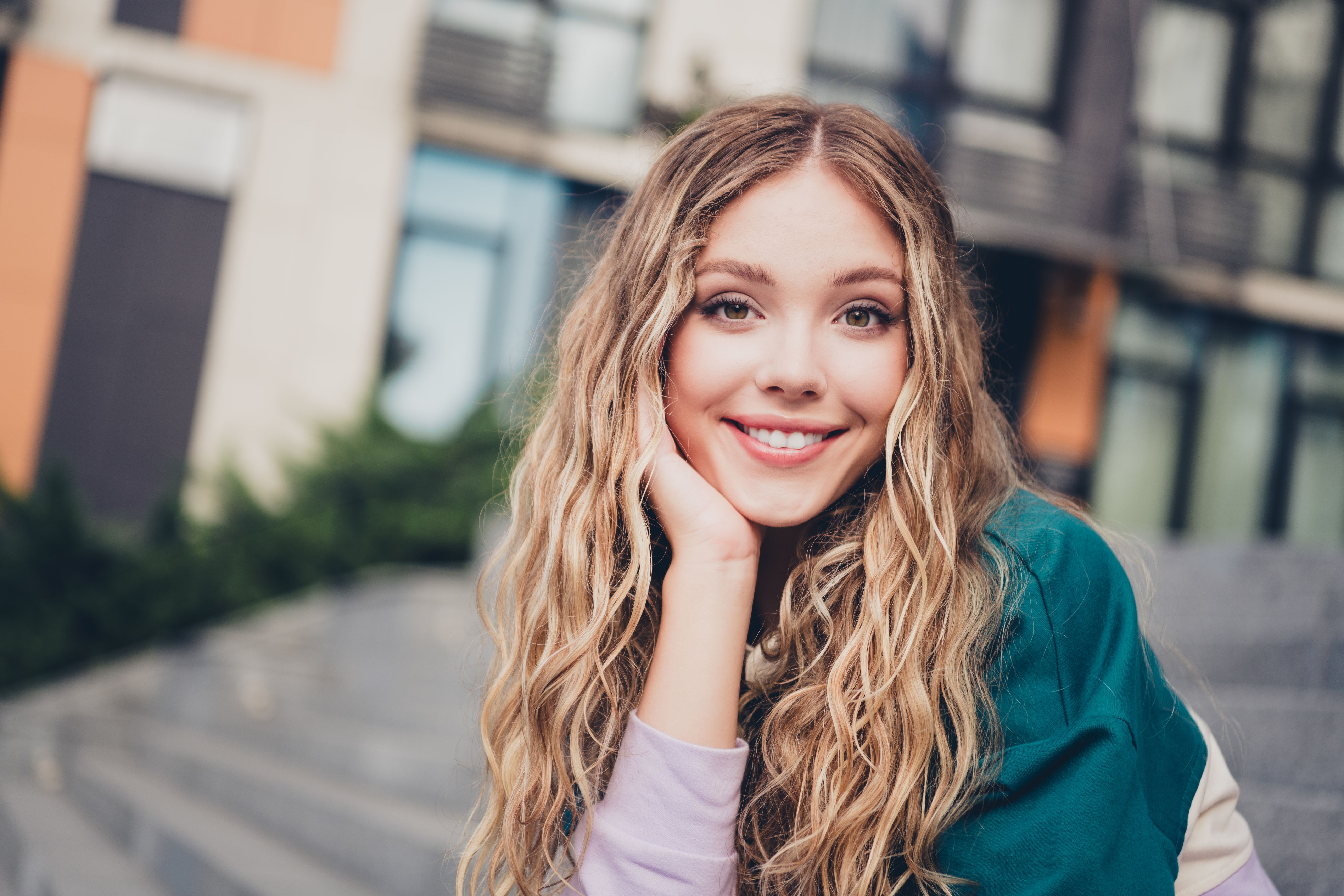 Photo of nice young girl sit stairs beaming smile wear top downtown street outdoors Photo of nice young girl sit stairs beaming smile wear top downtown street outdoors