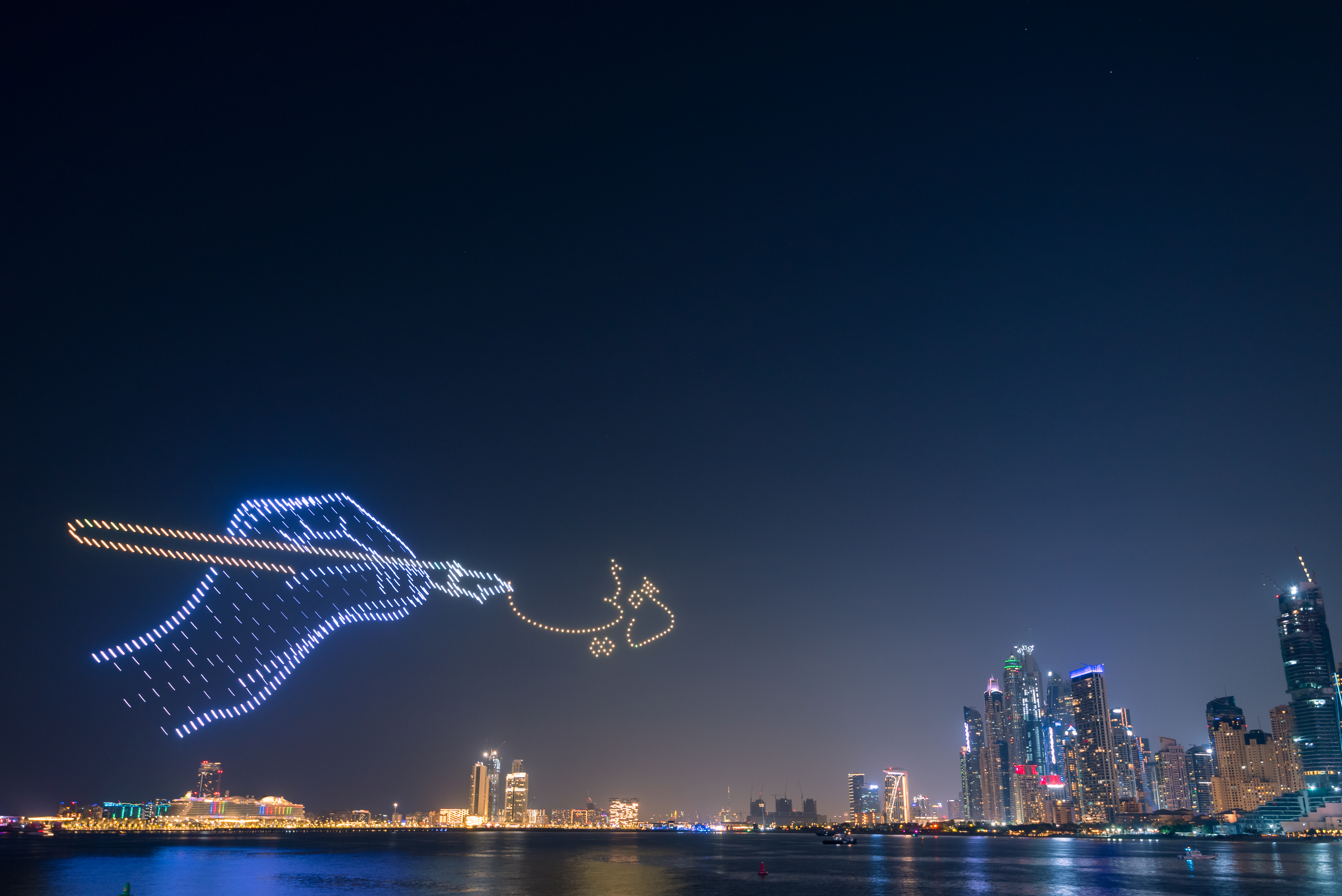 Drone show between Jumeirah beach and blue water al ain wheel promoting Dubai Shopping Festival.