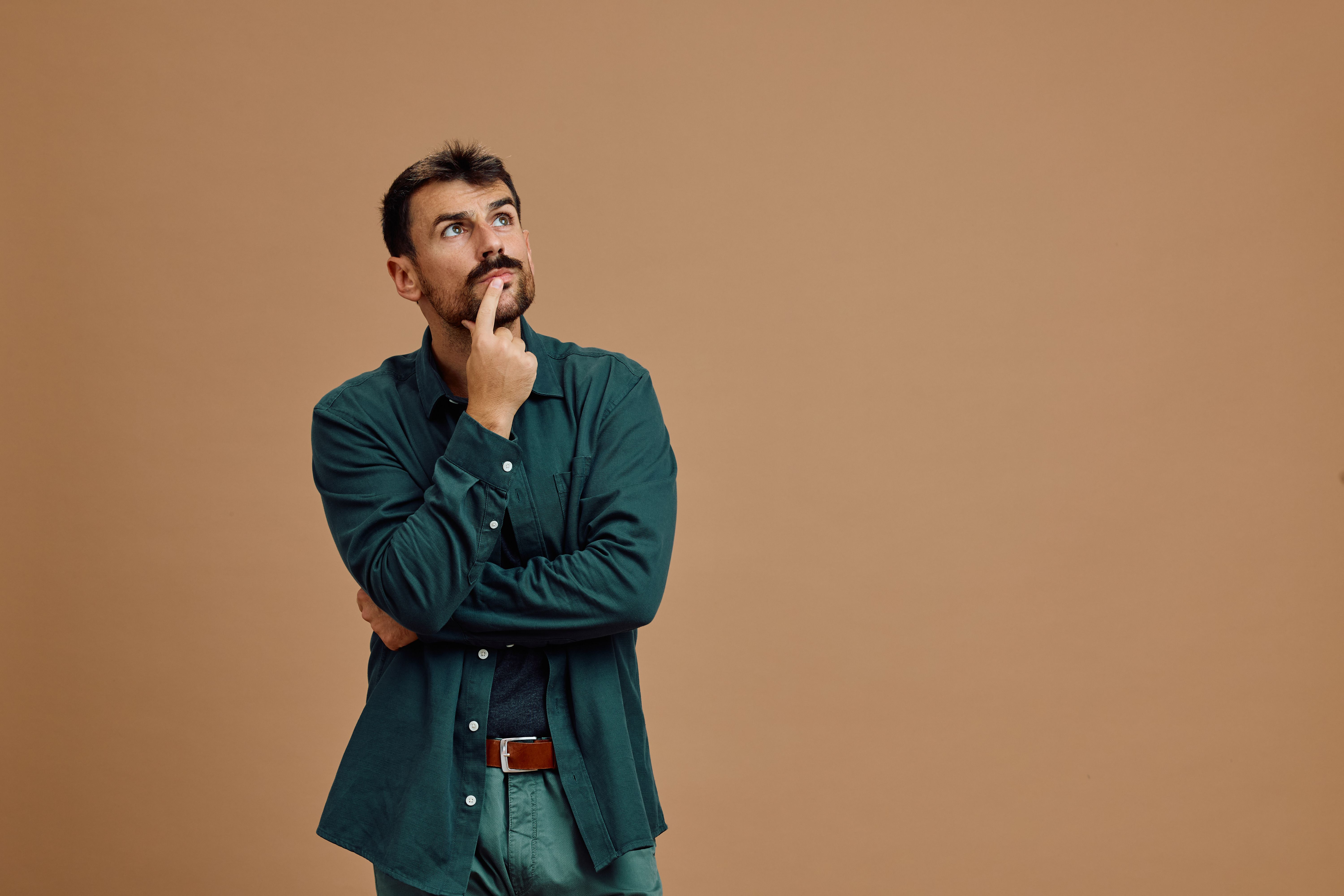 Portrait of thoughtful man looking up. Portrait of thoughtful man looking up.