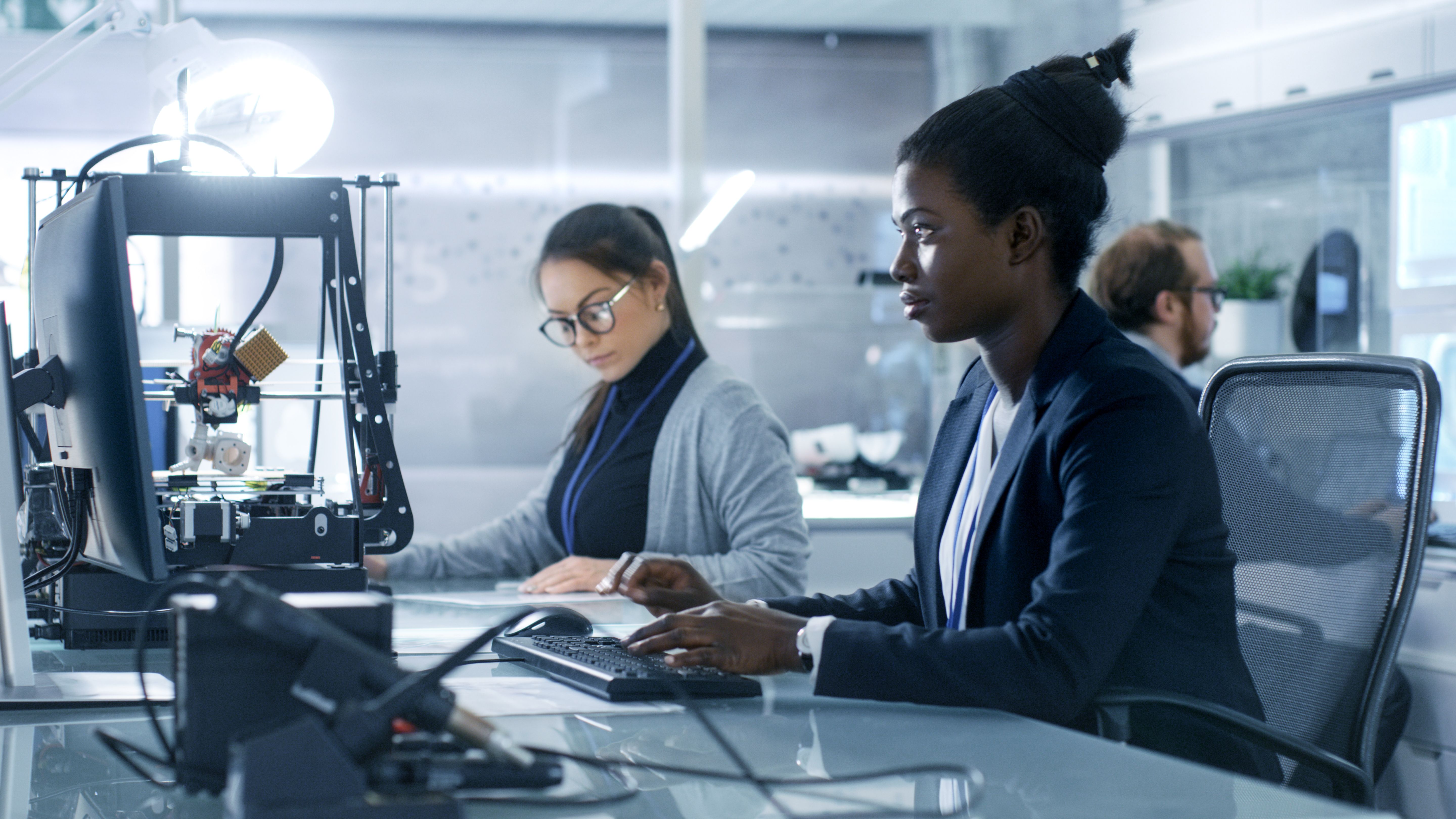 Black Female Scientist Working on a Computer with Her Colleagues at Research Center.