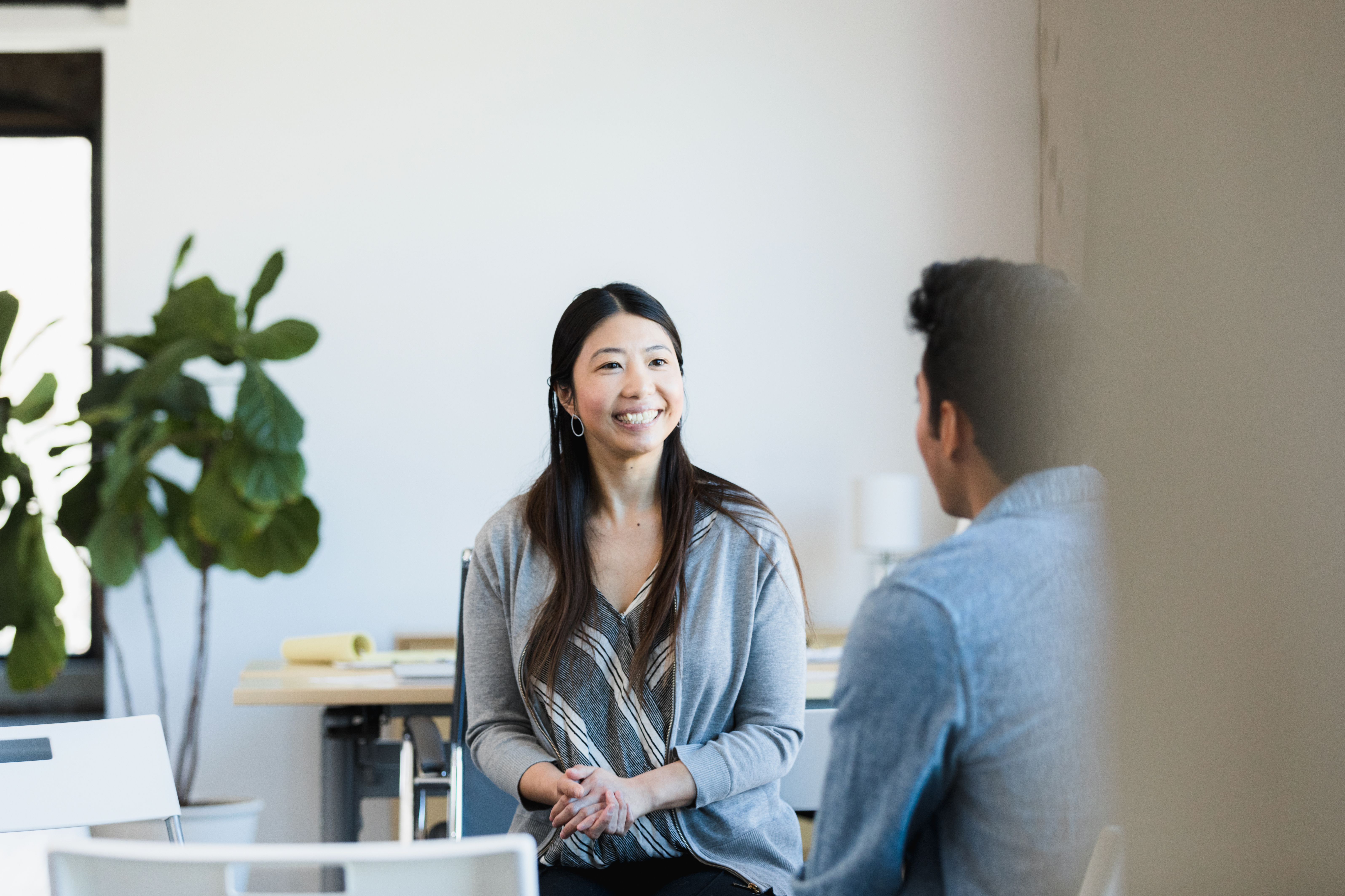 Mid adult female business owner smiles at job applicant