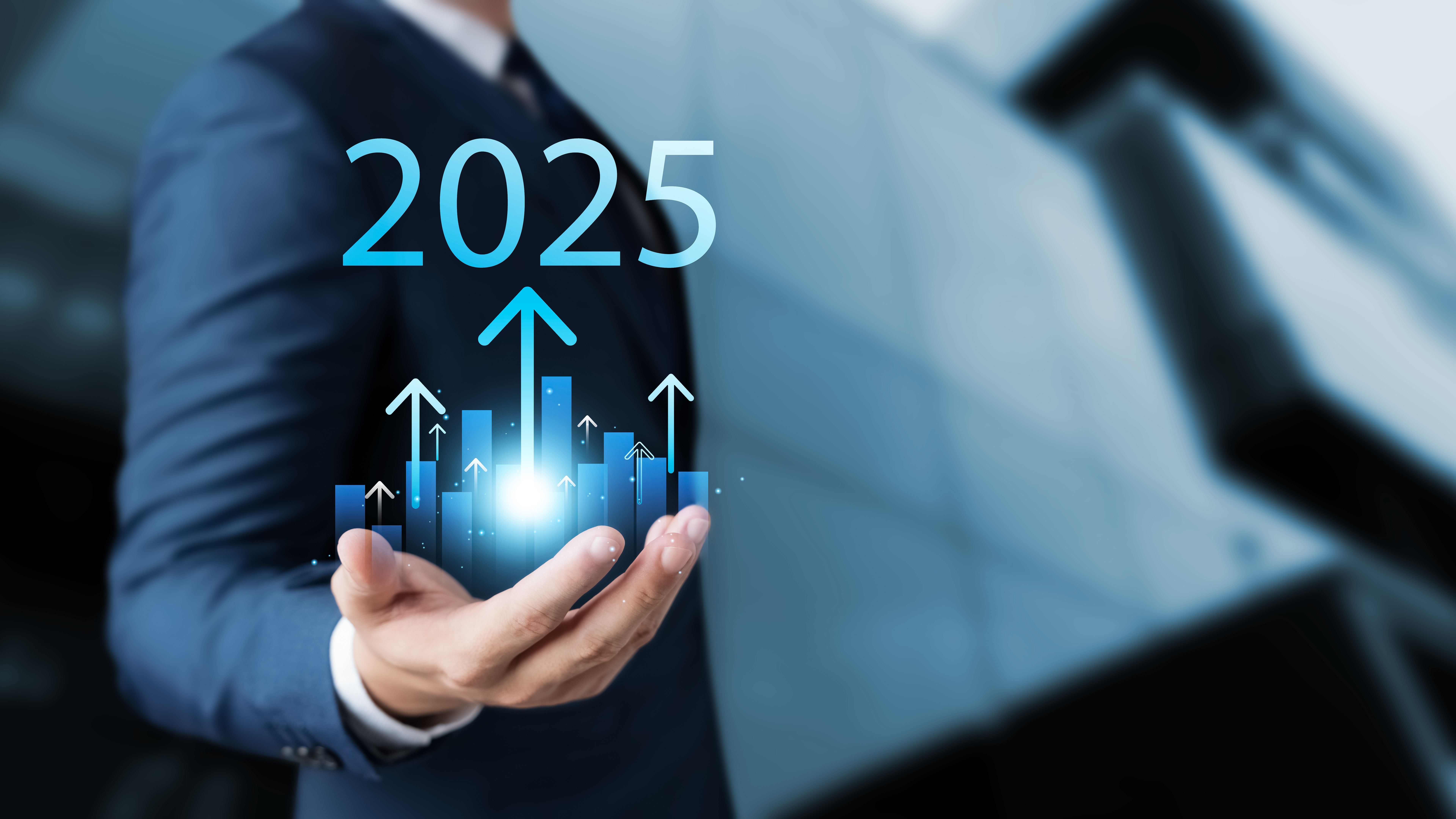 Set business goals for 2025, businessman holds up arrow charging graph Show business growth.