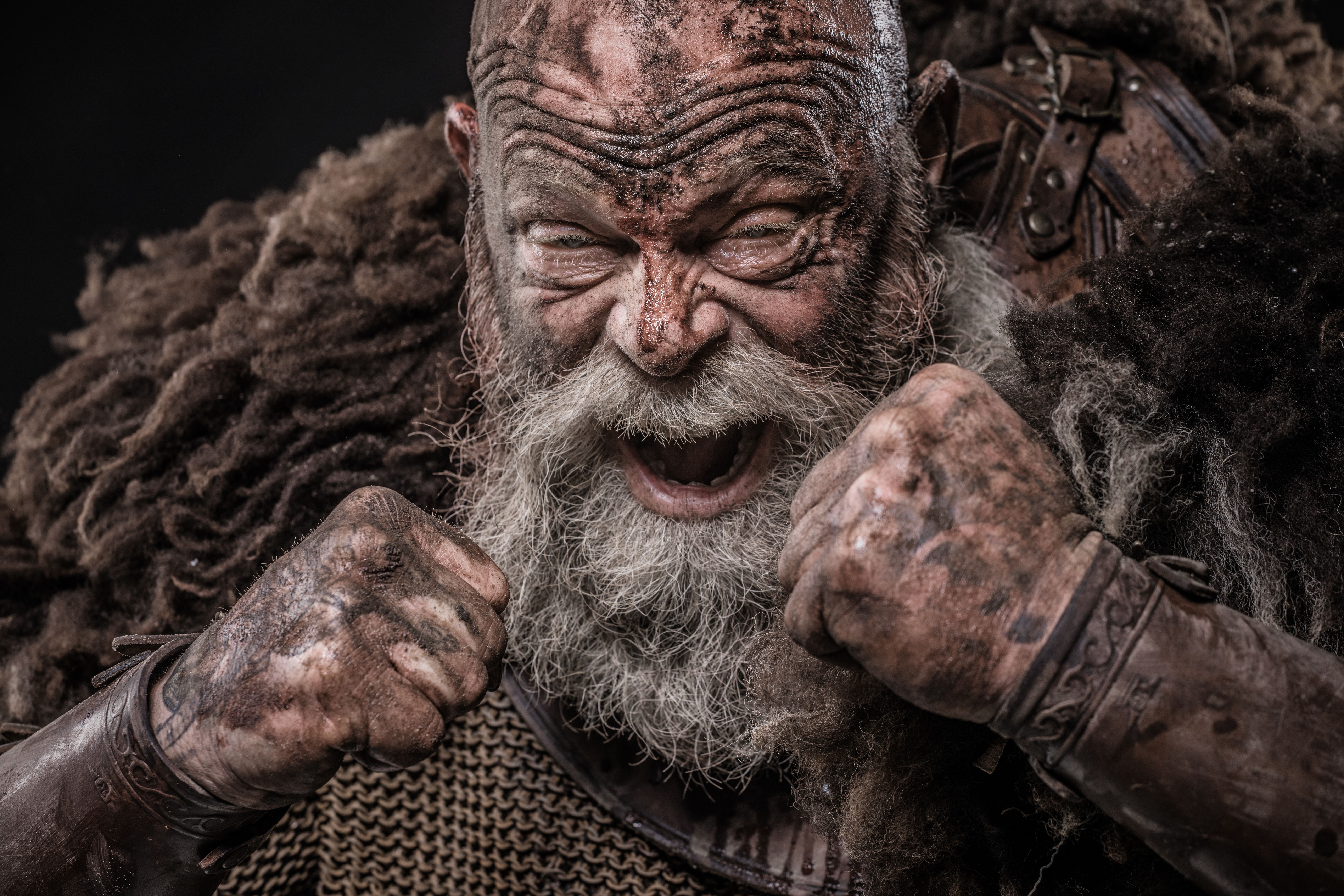 Weapon wielding senior viking warrior in studio shot