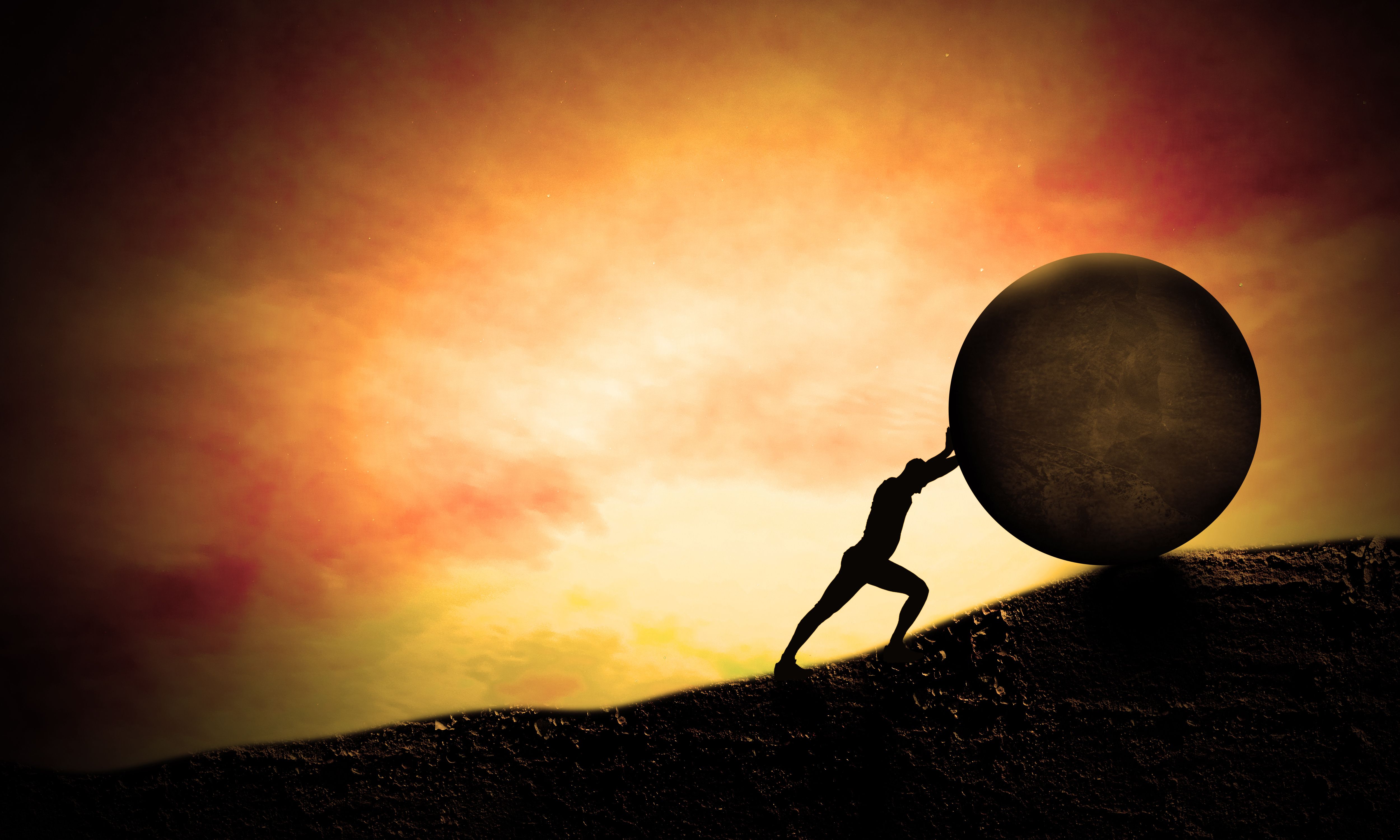 Young Business man Pushing Big stone up to hill. Sunset scene. Concept of Heavy tasks and problems, Difficulty and Hard Work. Sisyphus.