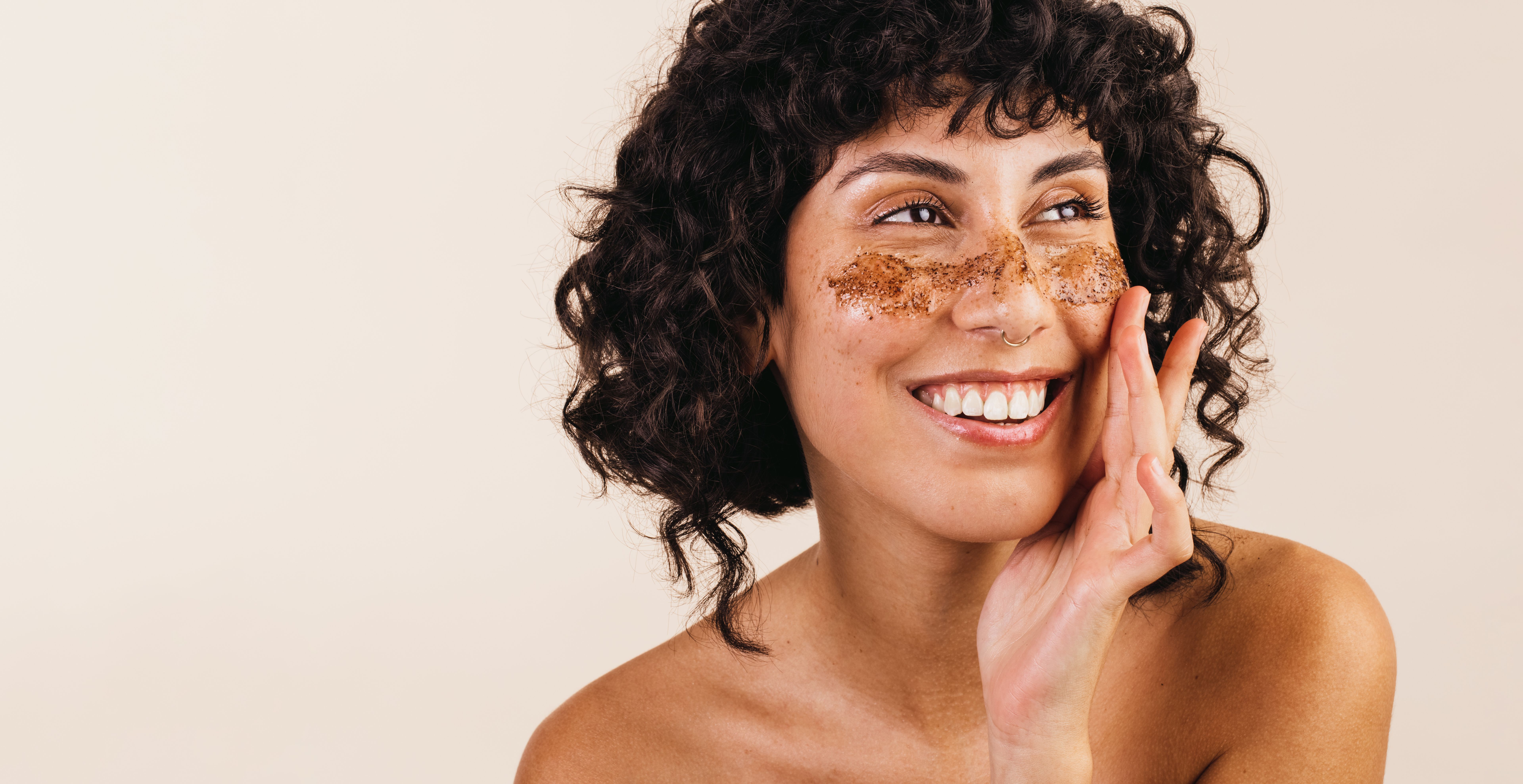 Woman treating her face with coffee scrub Woman treating her face with coffee scrub
