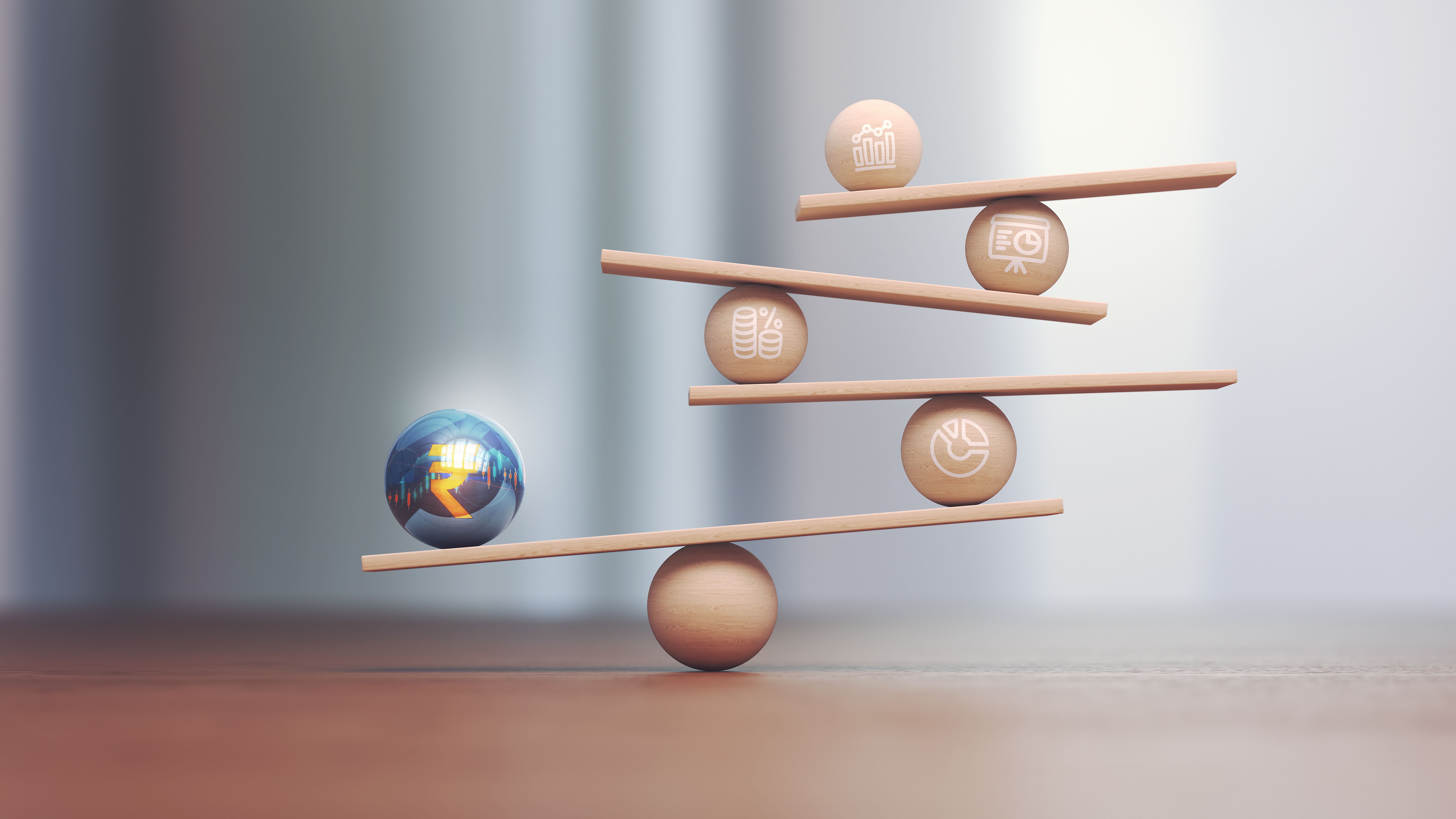 Blue Yellow Metal Ball Indian Rupee Symbol on Wooden Libra Scale and Wooden Financial Charts Depth Of Field