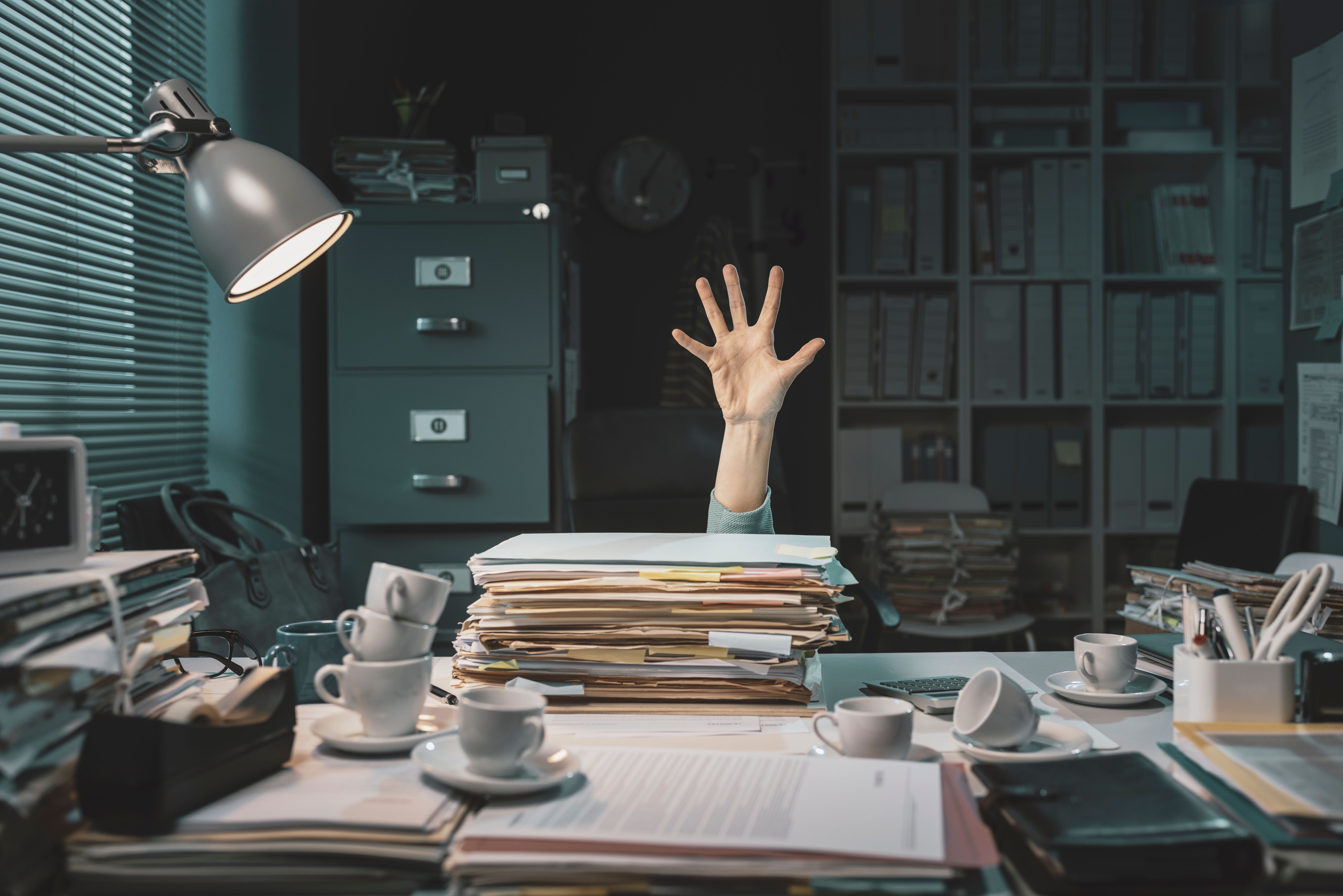 Office worker overwhelmed with paperwork Office worker overwhelmed with paperwork