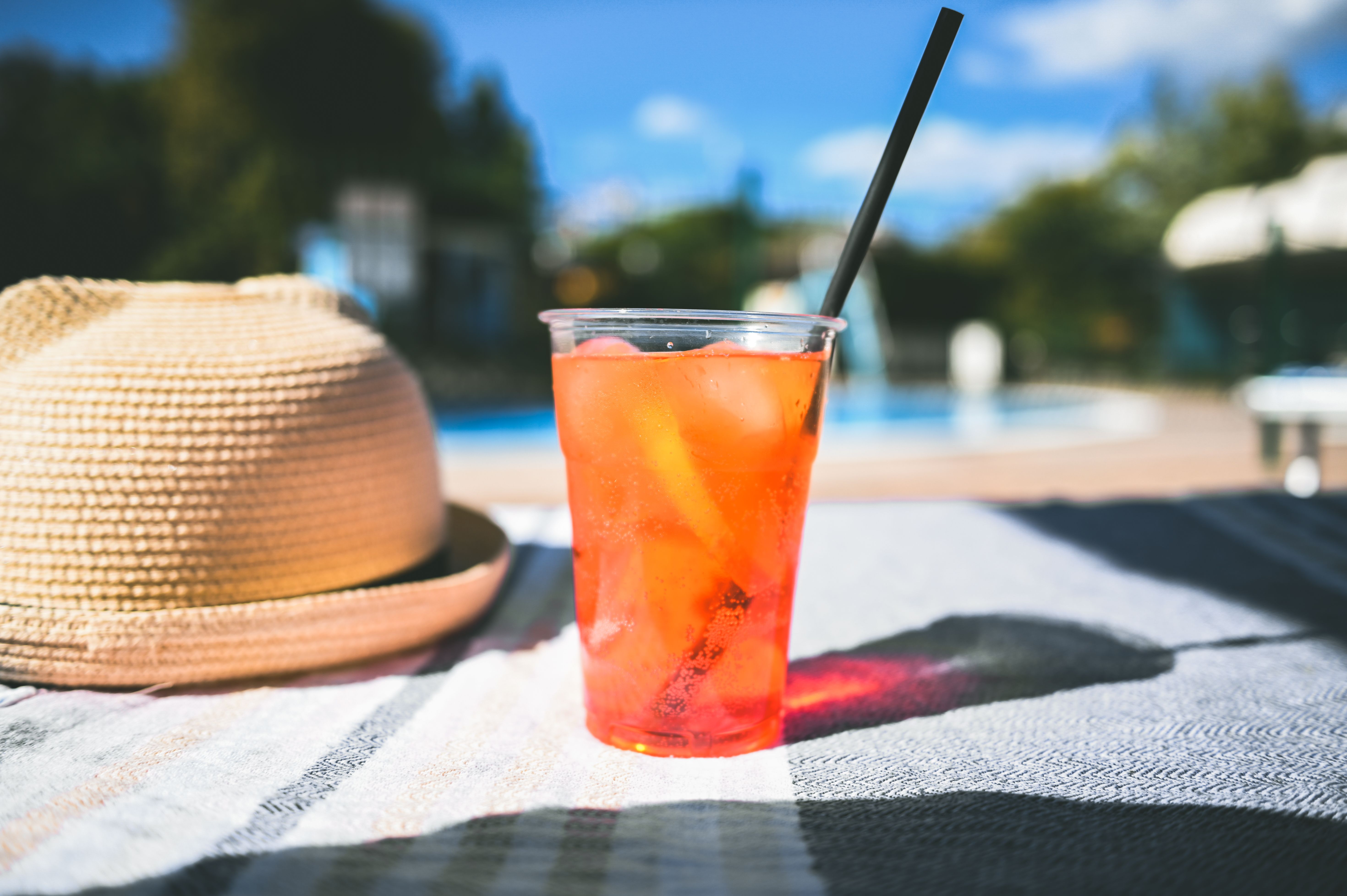 tropical cocktail on a chaise lounge in hot summer day. tropical cocktail on a chaise lounge in hot summer day.