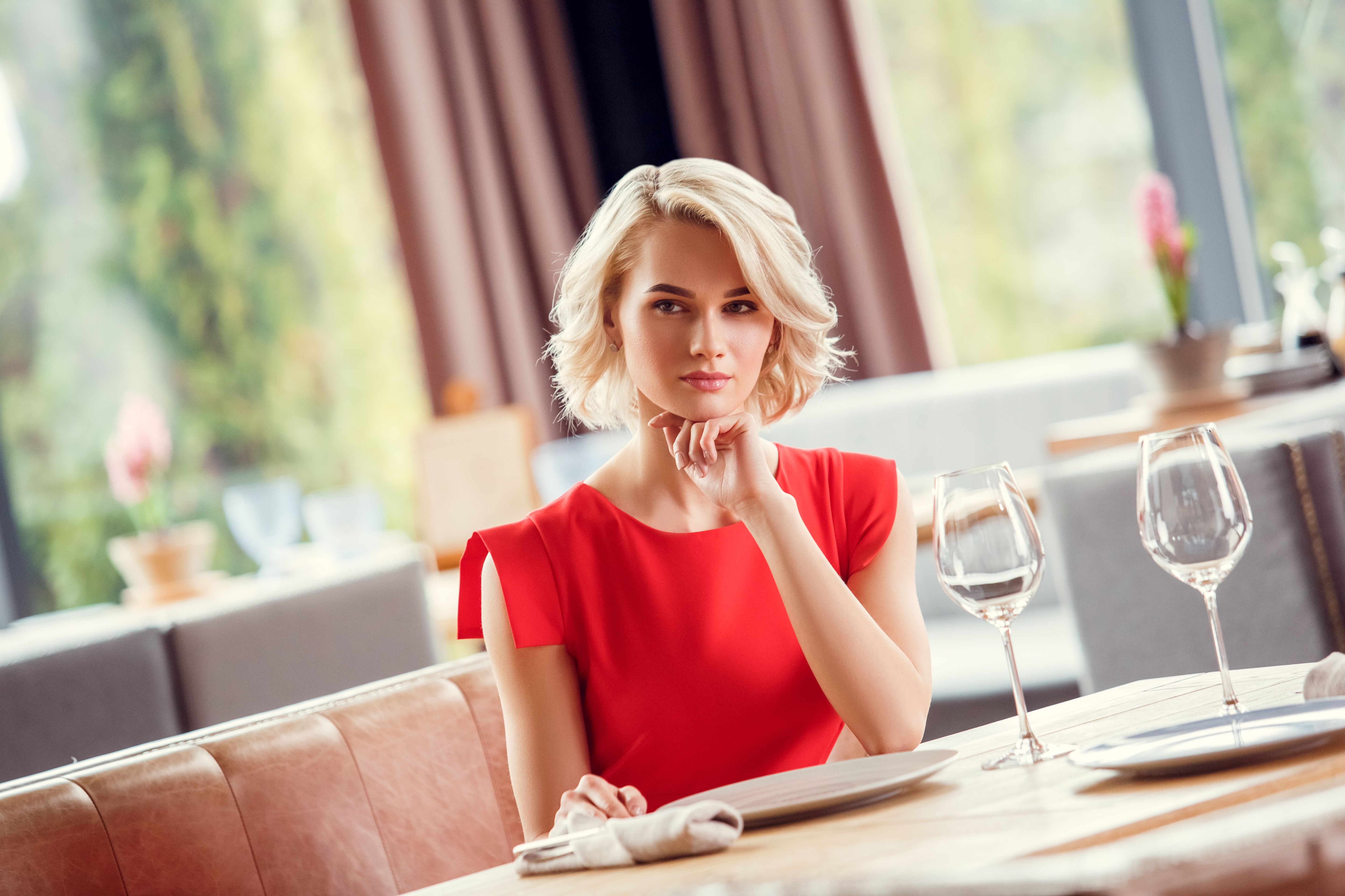Young woman on date in restaurant sitting thinking confident Young woman on date in restaurant sitting thinking confident