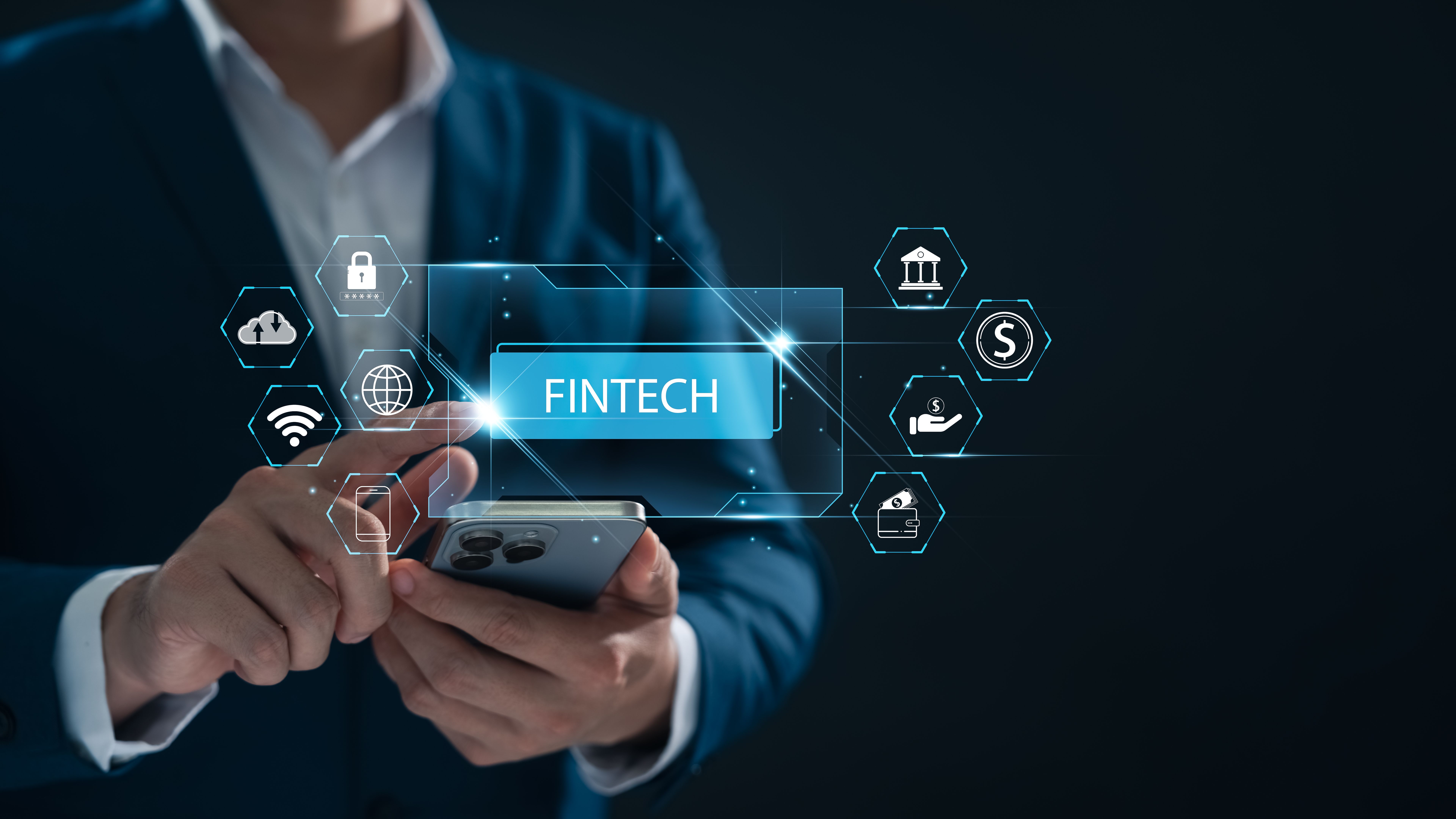 FinTech Financial Technology and Digital Banking, Businessman holding the word FinTech.