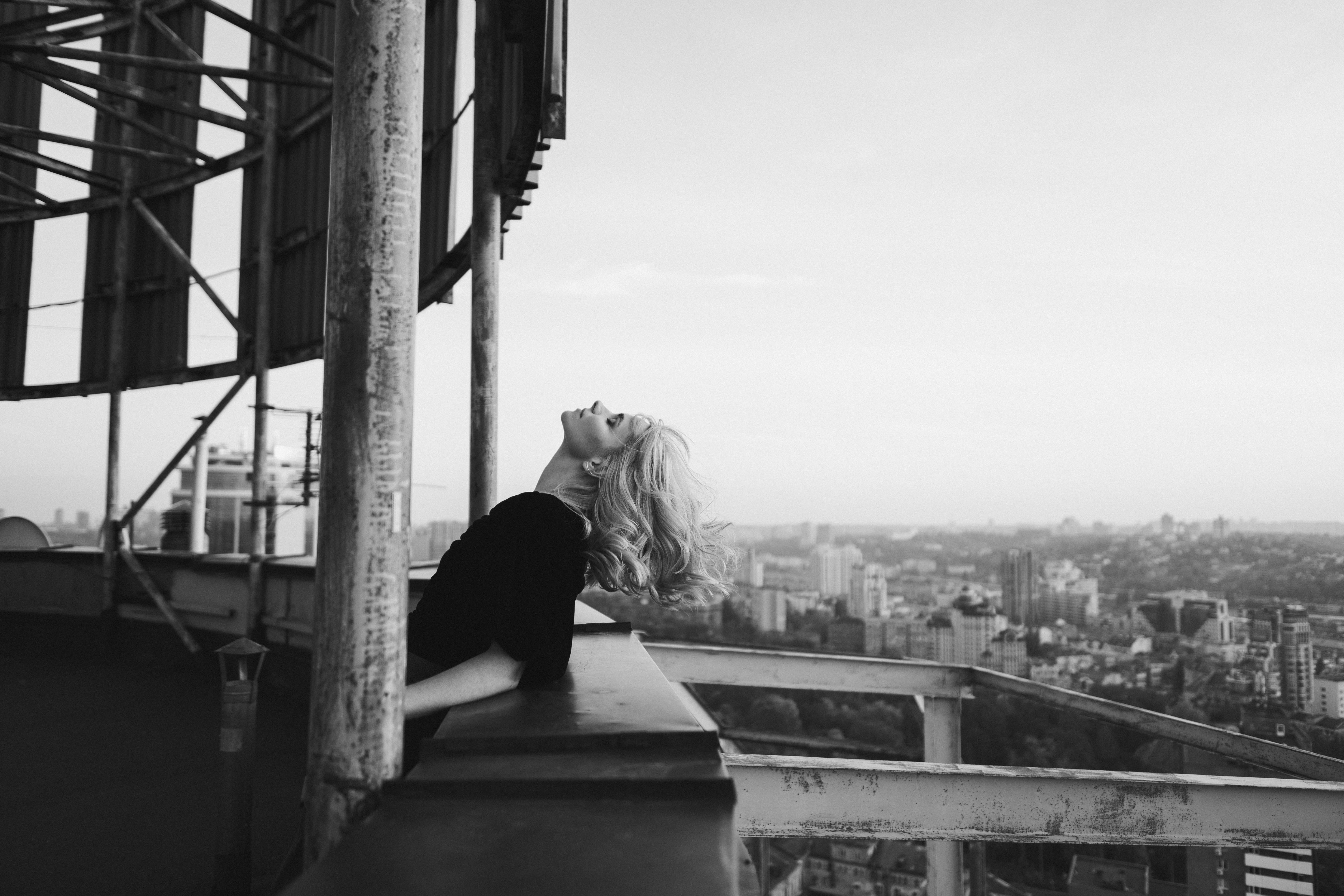 Romantic and beautiful caucasian woman in stylish clothes on the rooftop enjoying herself and the city view. Romantic and beautiful caucasian woman in stylish clothes on the rooftop enjoying herself and the city view.