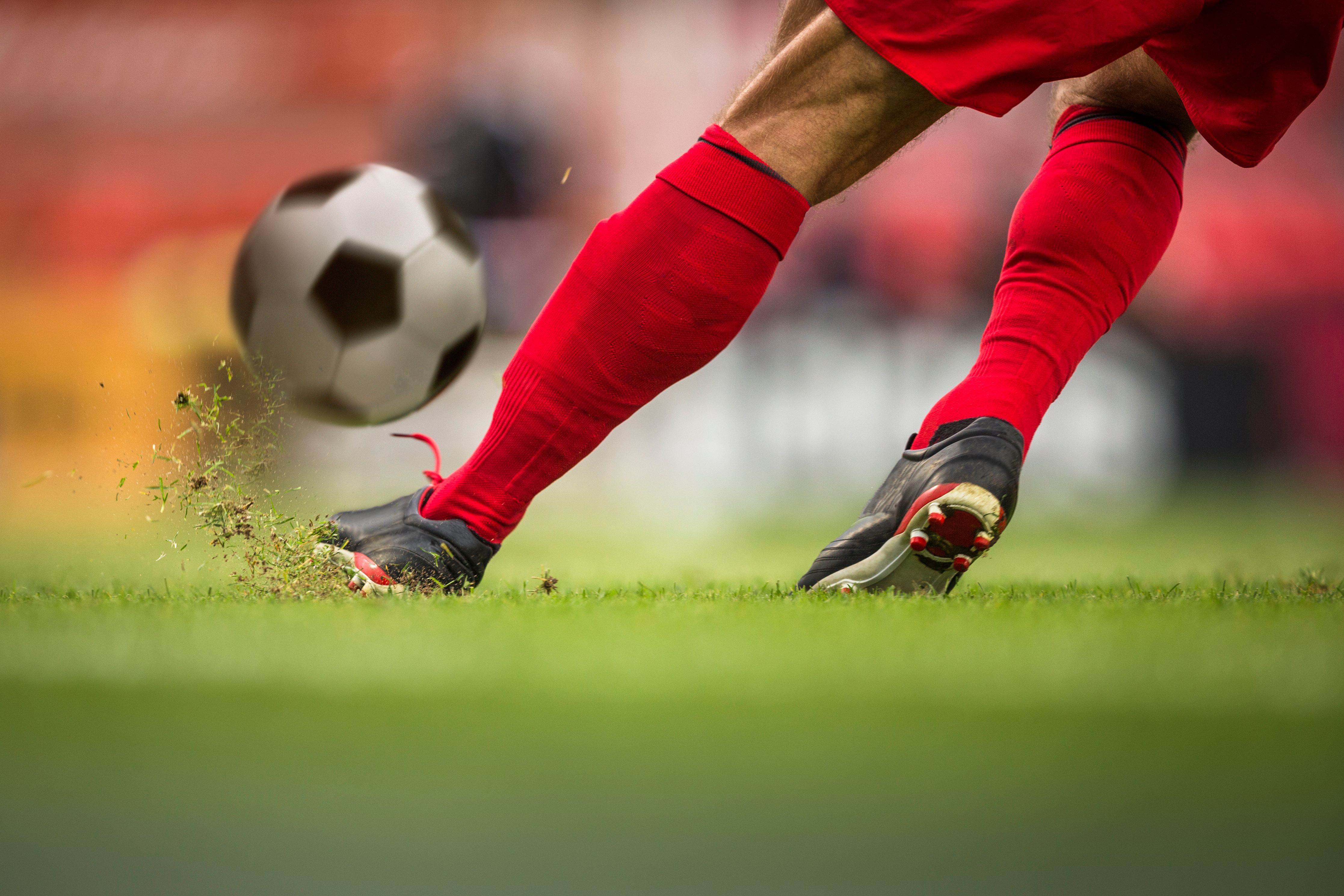 Soccer ball kick on the field
